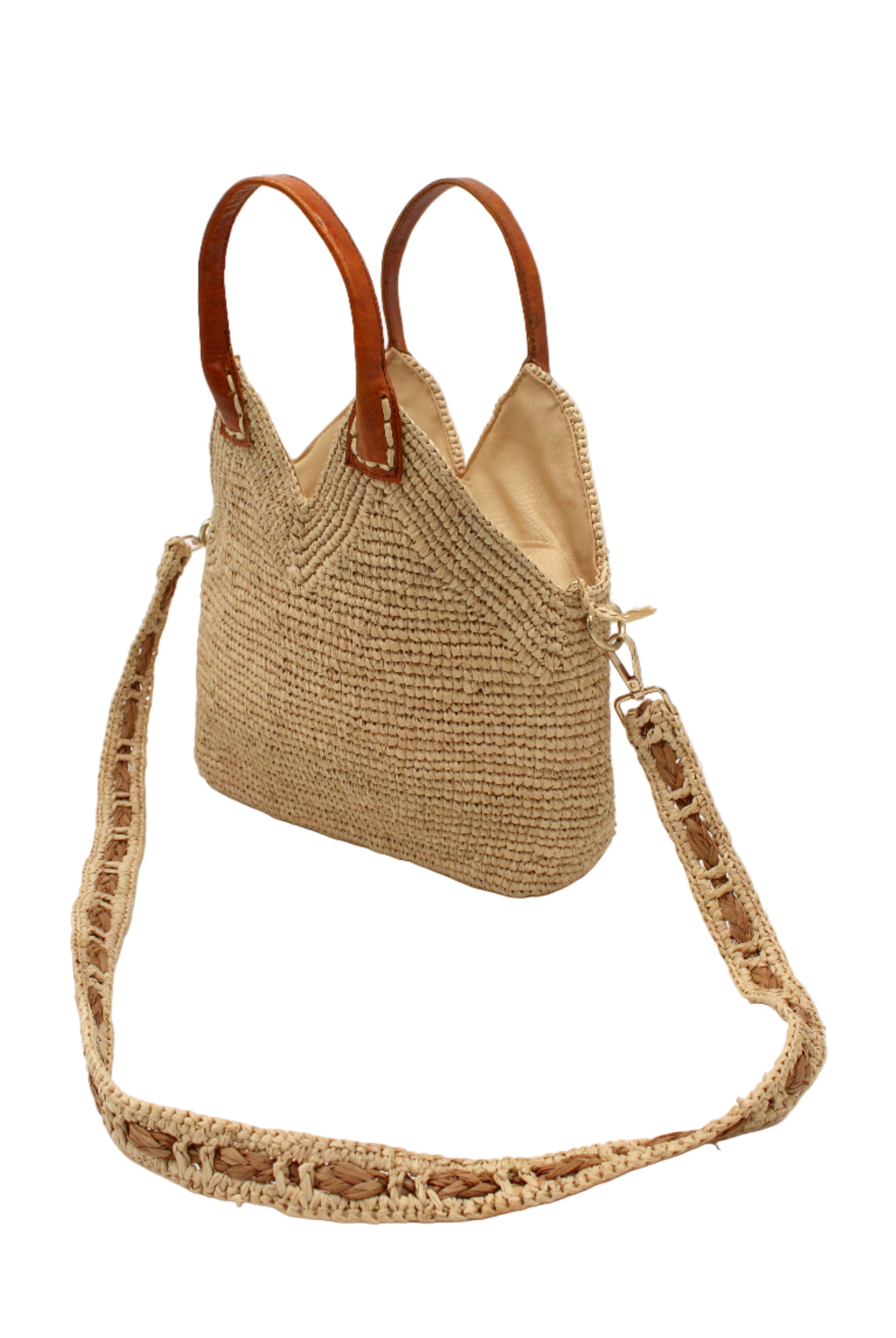 Side view Victoria Crochet Straw Handbag Convertible Crossbody Bag handmade crochet natural raffia palm fiber in a solid hue of natural straw color in a subtle texture of horizontal link bands pattern across the bag and m shape around the top of the bag with brown leather handles and removable two tone natural and cappuccino tea/light/brown crossbody strap convertible purse - Shebobo