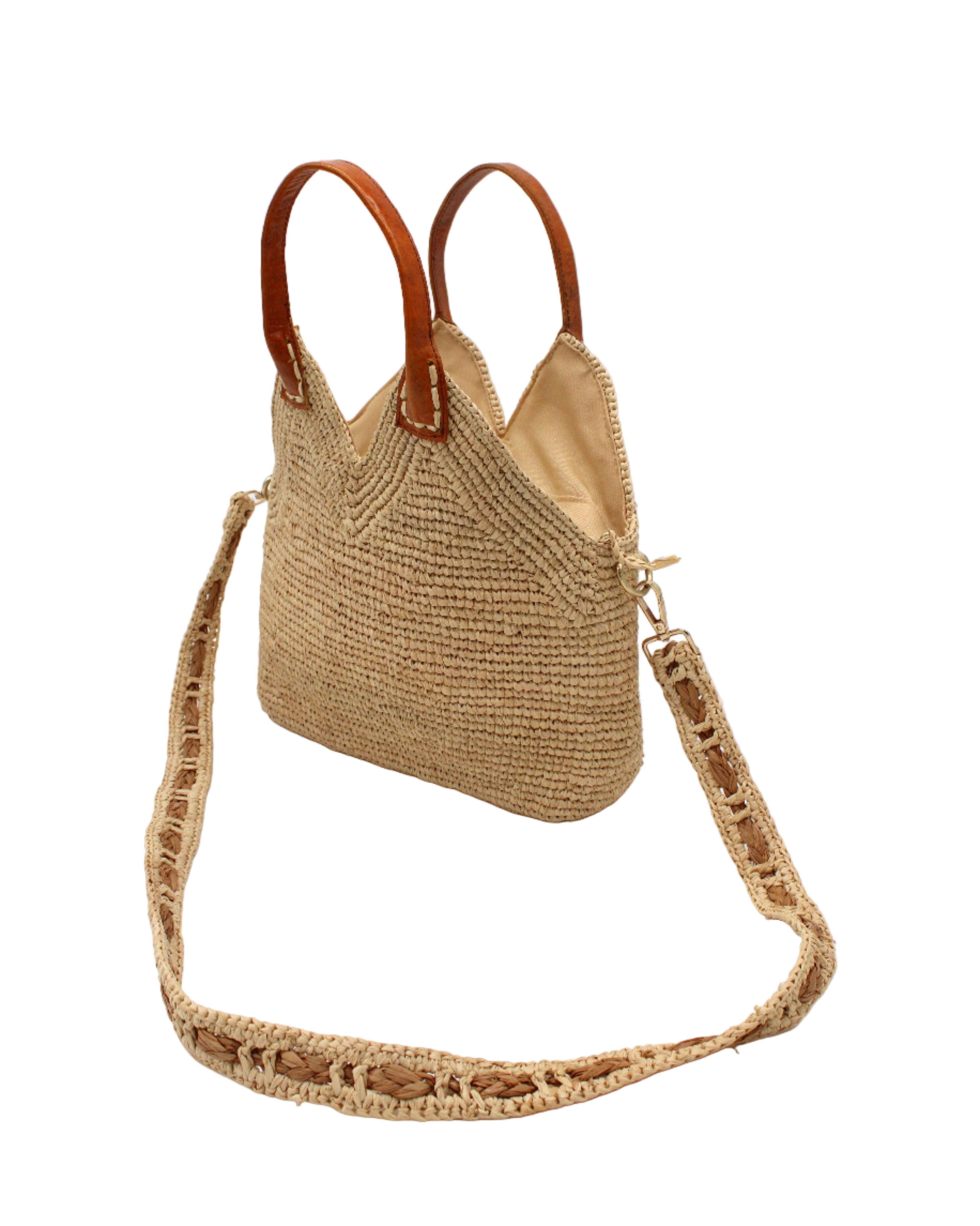 Side view Victoria Crochet Straw Handbag Convertible Crossbody Bag handmade crochet natural raffia palm fiber in a solid hue of natural straw color in a subtle texture of horizontal link bands pattern across the bag and m shape around the top of the bag with brown leather handles and removable two tone natural and cappuccino tea/light/brown crossbody strap convertible purse - Shebobo