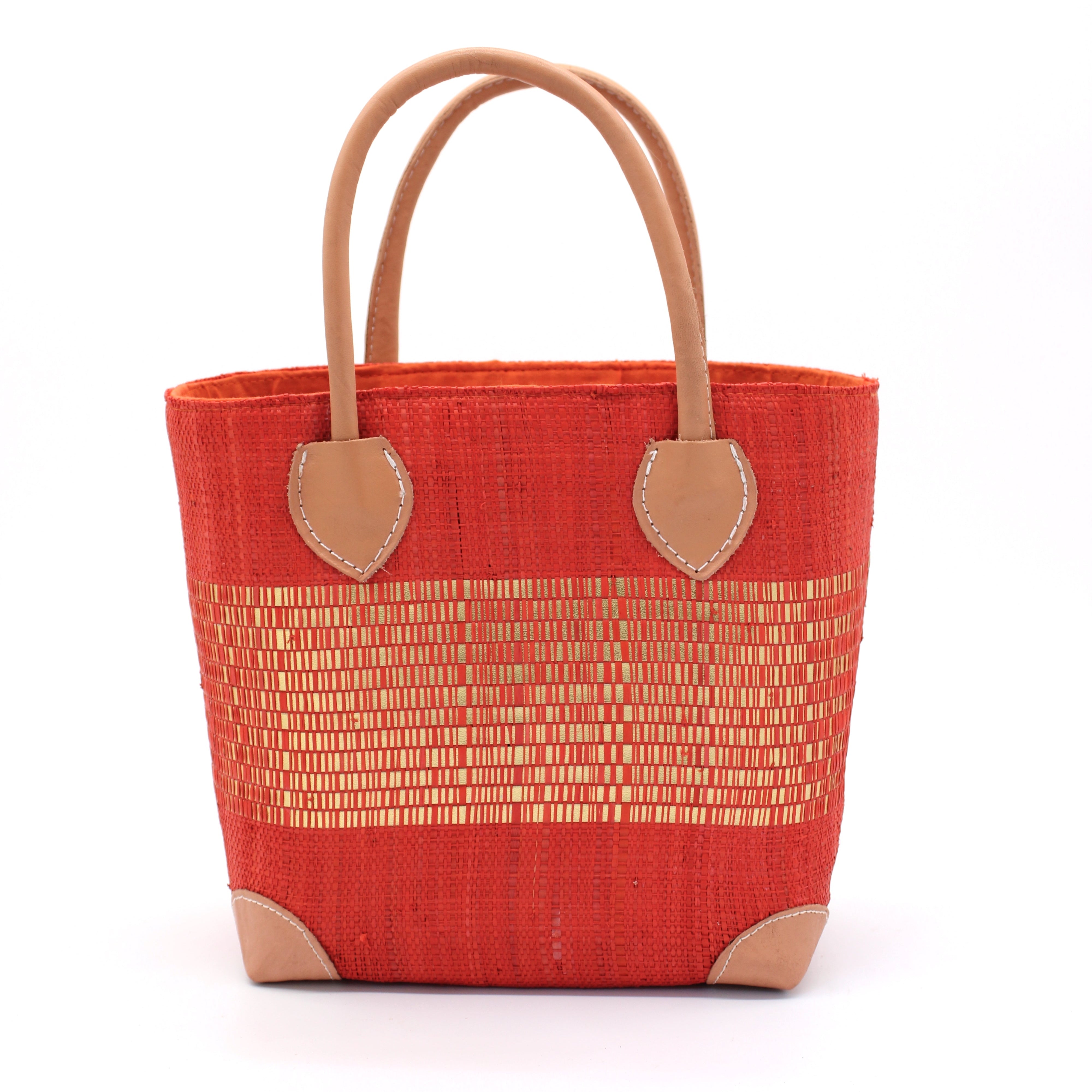 Wynwood Coral Straw Basket Bag with Metallic Detailing Handmade loomed raffia palm fiber in a solid hue of coral orange/red with a wide horizontal band of metallic strands woven in seamlessly handbag purse with leather handles - Shebobo