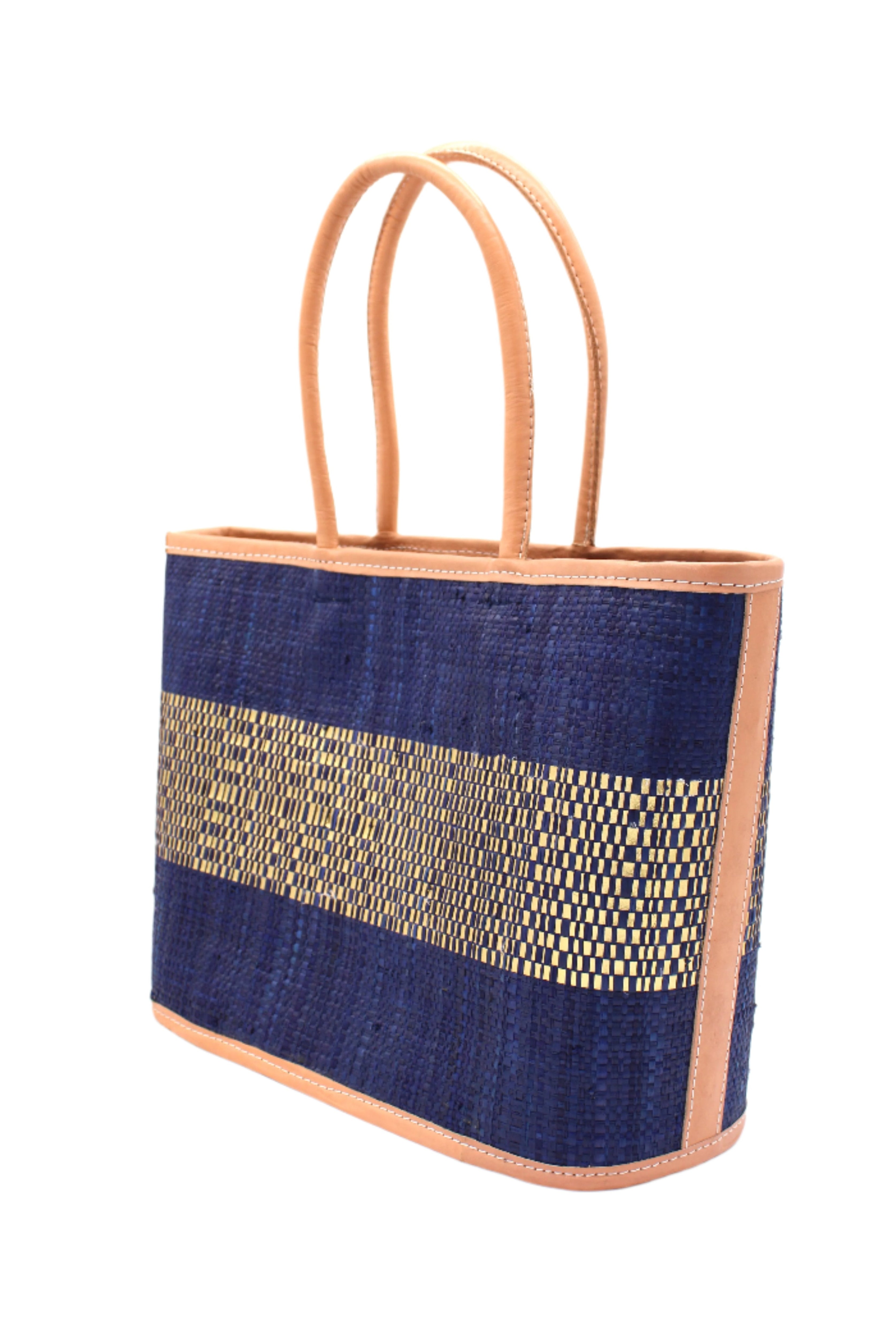 Side View Wynwood Blue Straw Basket Bag Handbag with Metallic Detailing handmade loomed raffia in blue and silver metallic vegan leather in three evenly sized horizontal bands of color with the metallic weave centered on the purse with leather binding and handles - Shebobo