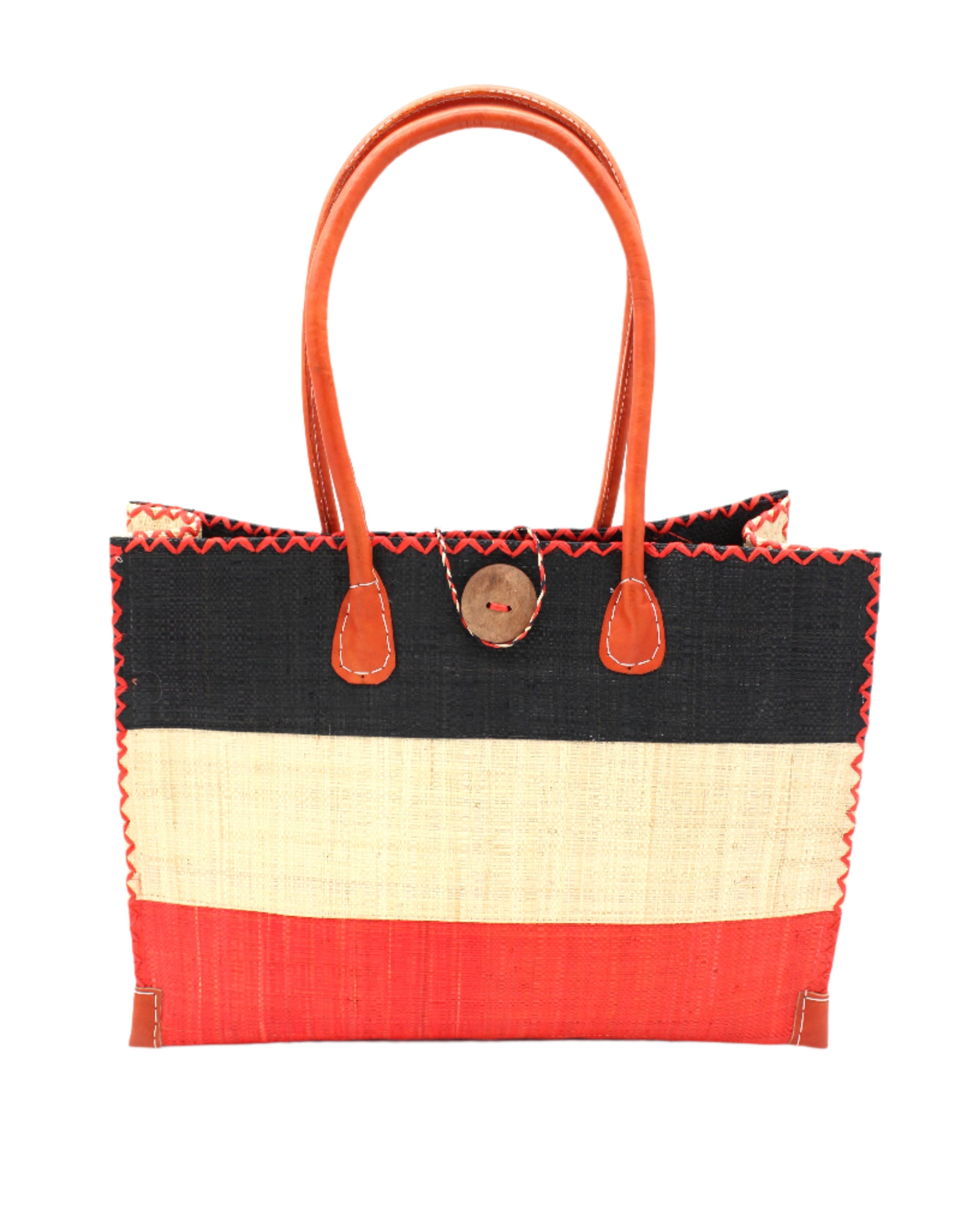 Zafran 3 Tone Color Block Beach Straw Bag with Plastic Liner handmade loomed raffia palm fiber in three equally sized horizontal bands of black, natural straw color, and coral red/orange with wood button and leather handles - Shebobo