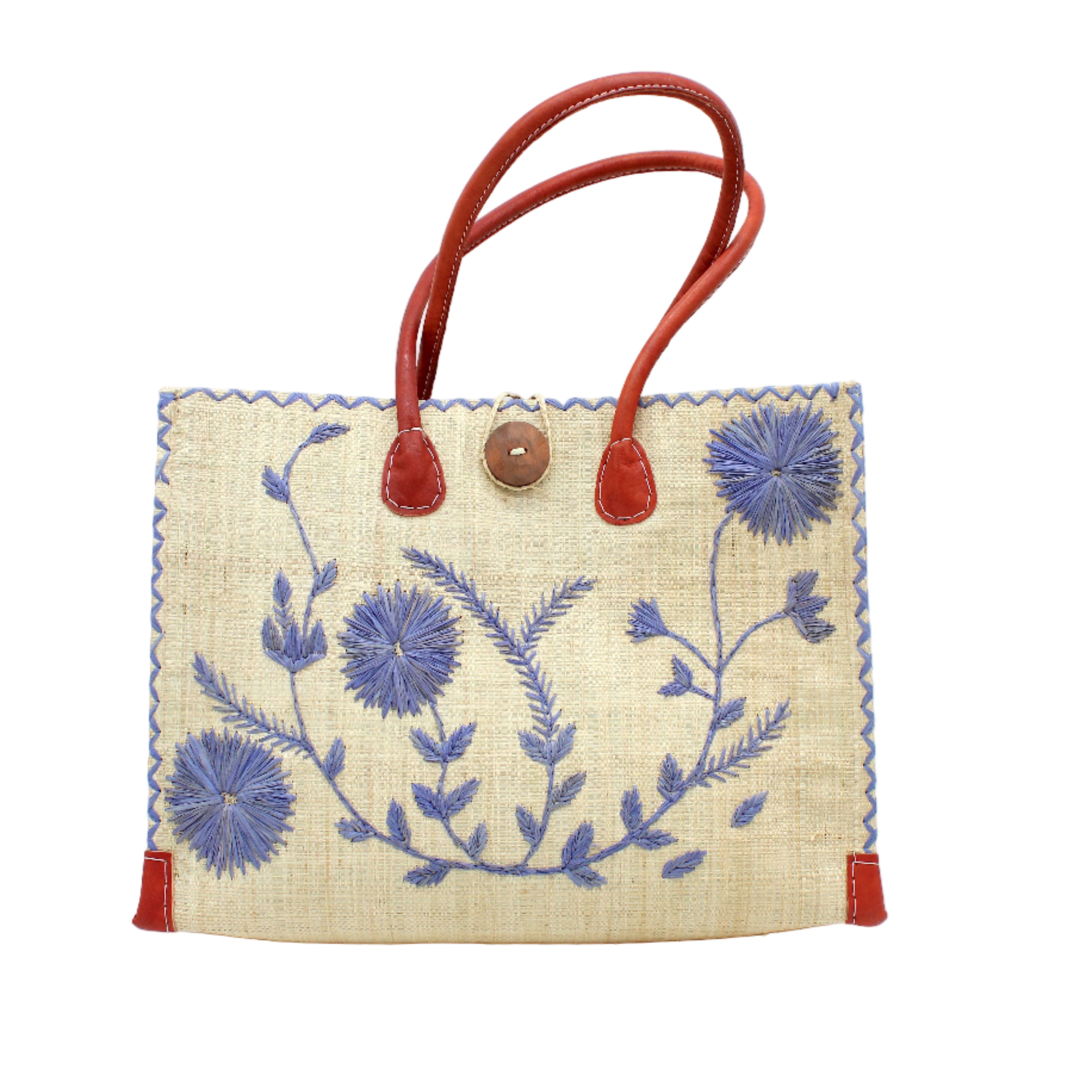 Zafran Natural & Denim Embroidered Straw Beach Bag with Floral Pattern handmade natural raffia palm fiber in a solid hue of natural straw color with asymmetrical floral leaf, vine, and flower pattern in denim retro/light/blue with matching cross-stitch edging, leather handles, and wooden button closure shoulder bag handbag tote - Shebobo