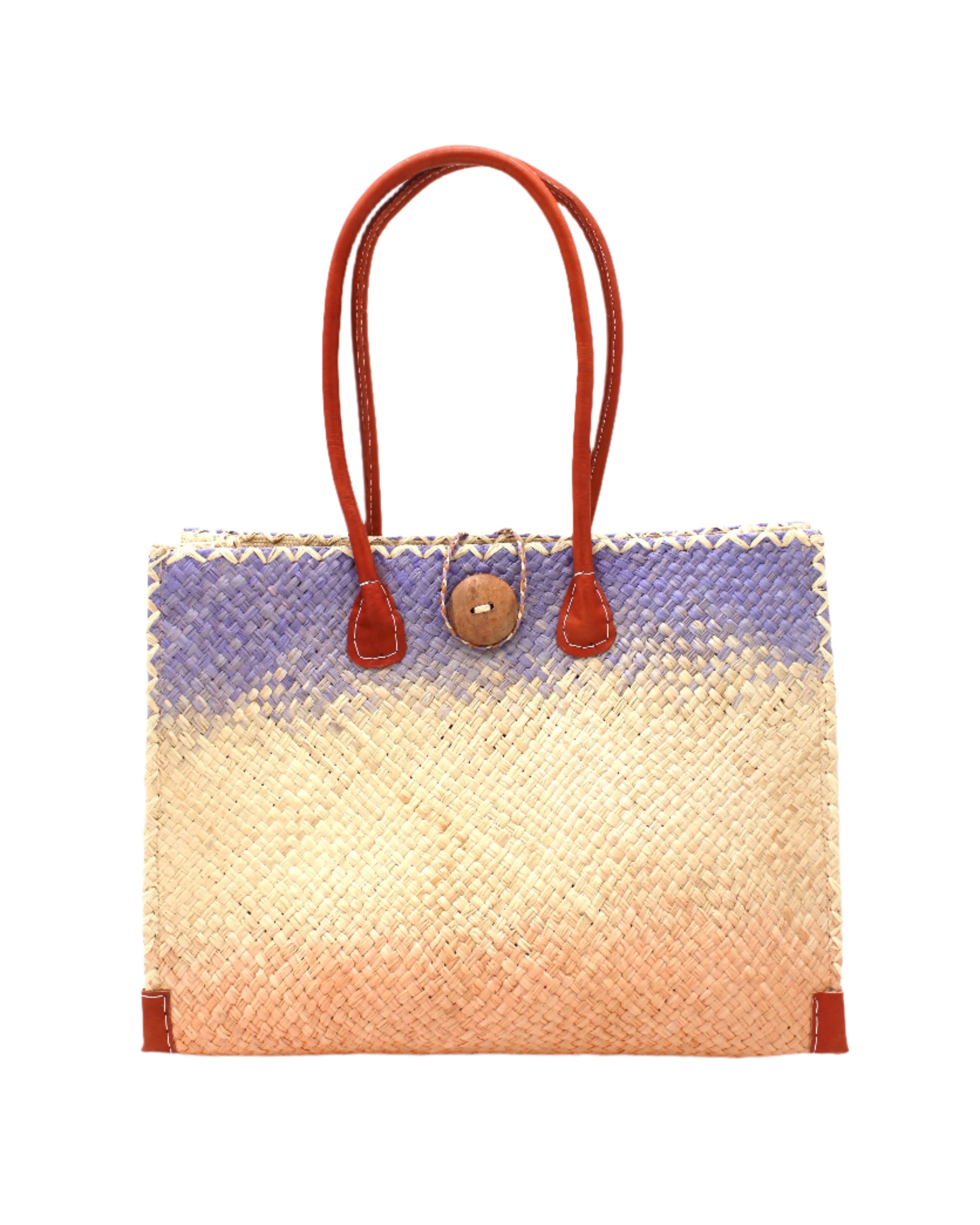 Holden Fuchsia Ombre Zafran Straw Beach Bags handmade dip dyed raffia woven into a three part horizontal ombre pattern of wisteria lavender/lilac/light/purple, natural straw color, and blush pink/orange with cross stitch edging, wooden button, and leather handles - Shebobo