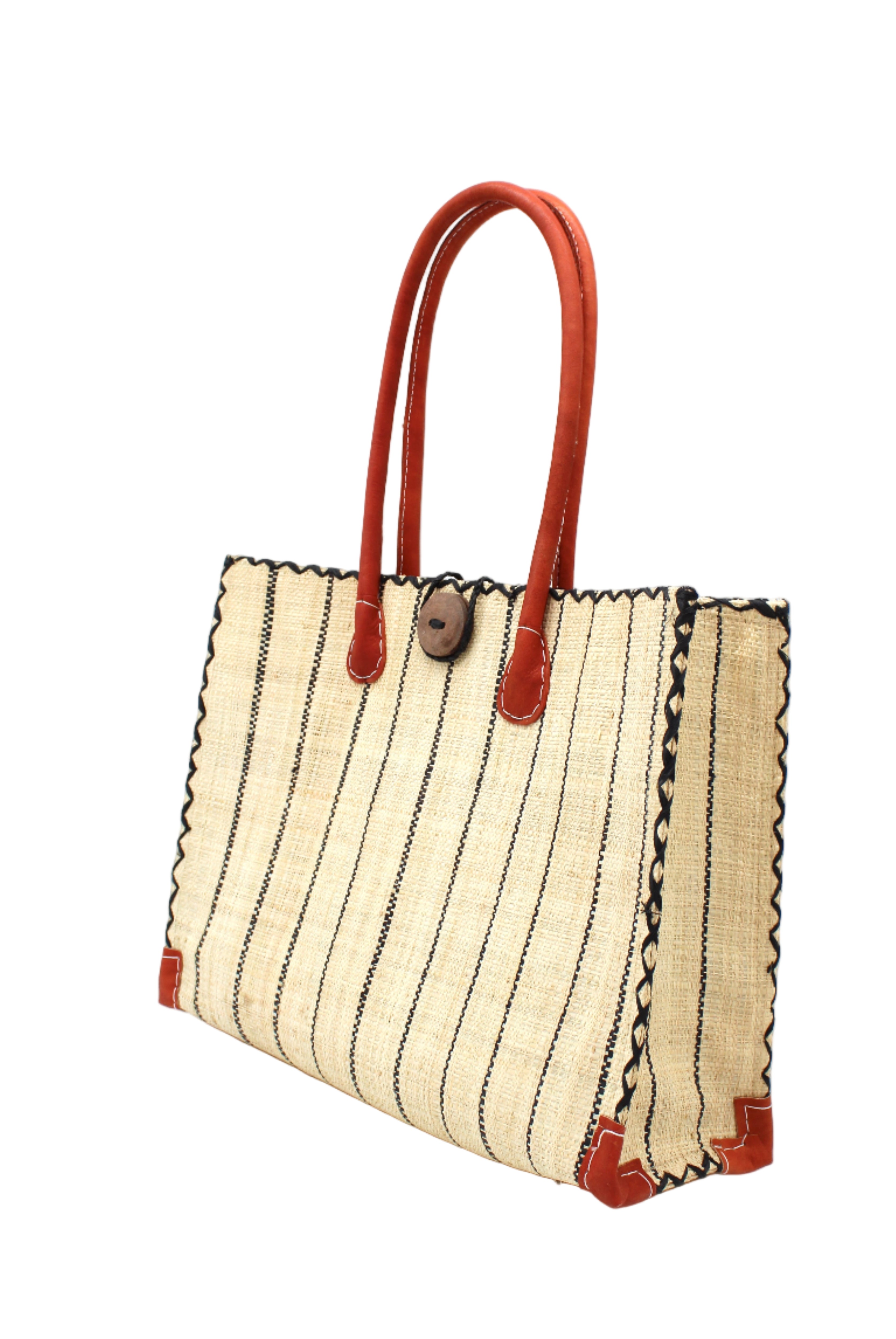 Side view Zafran Natural Pinstripes Large Straw Beach Bag with Plastic Liner handmade loomed raffia tote in wide bands of natural straw color with narrow bands of black that make a vertical pinstripe pattern with assorted print plastic lining and leather handles xl bag - Shebobo