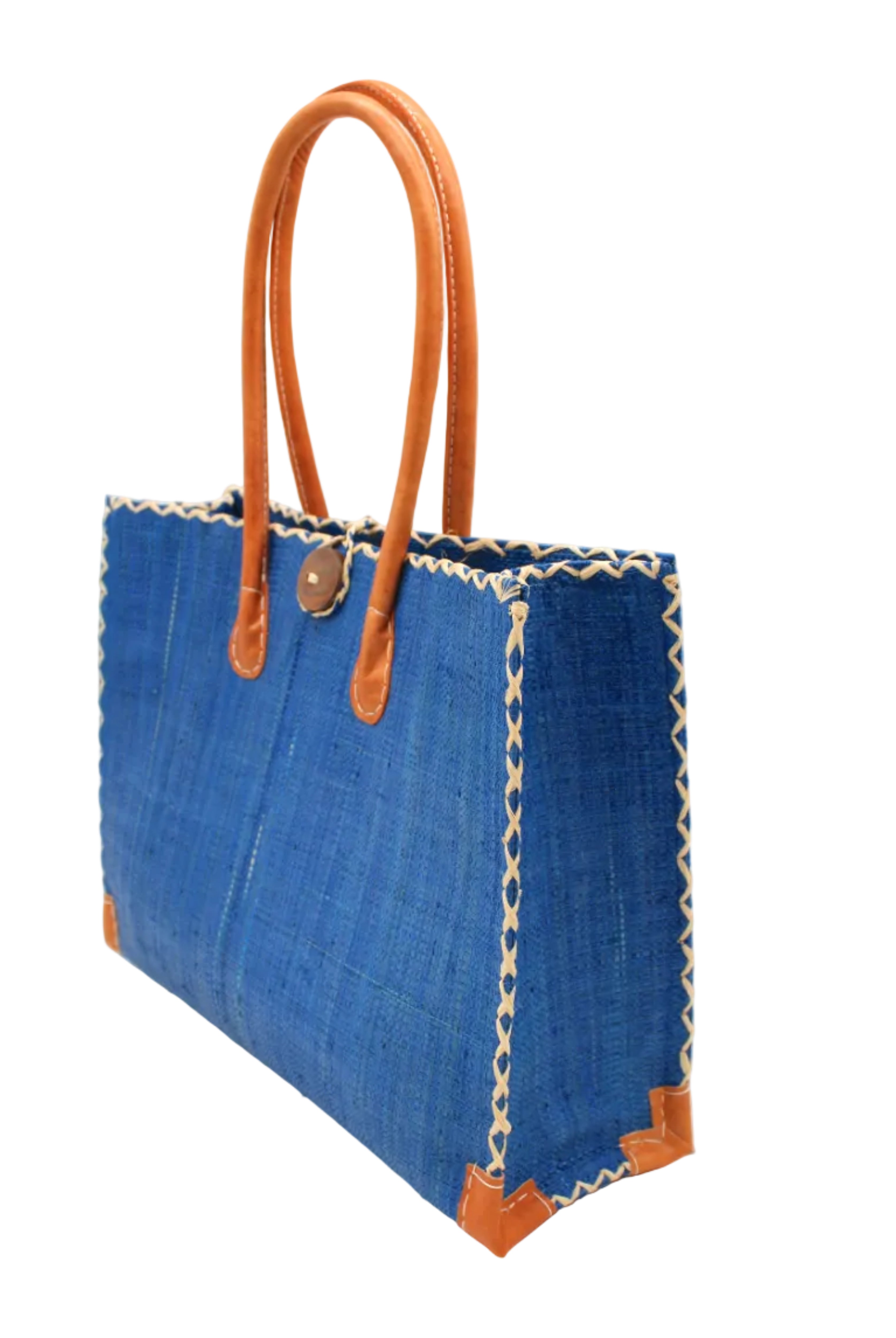 Side view Zafran Straw Beach Bag with Plastic Liner handmade loomed raffia in a solid hue of Azure intense/bright/blue with contrasting natural straw color cross stitch edge binding, wood button closure, and leather handles & feet plus assorted print plastic lining - Shebobo