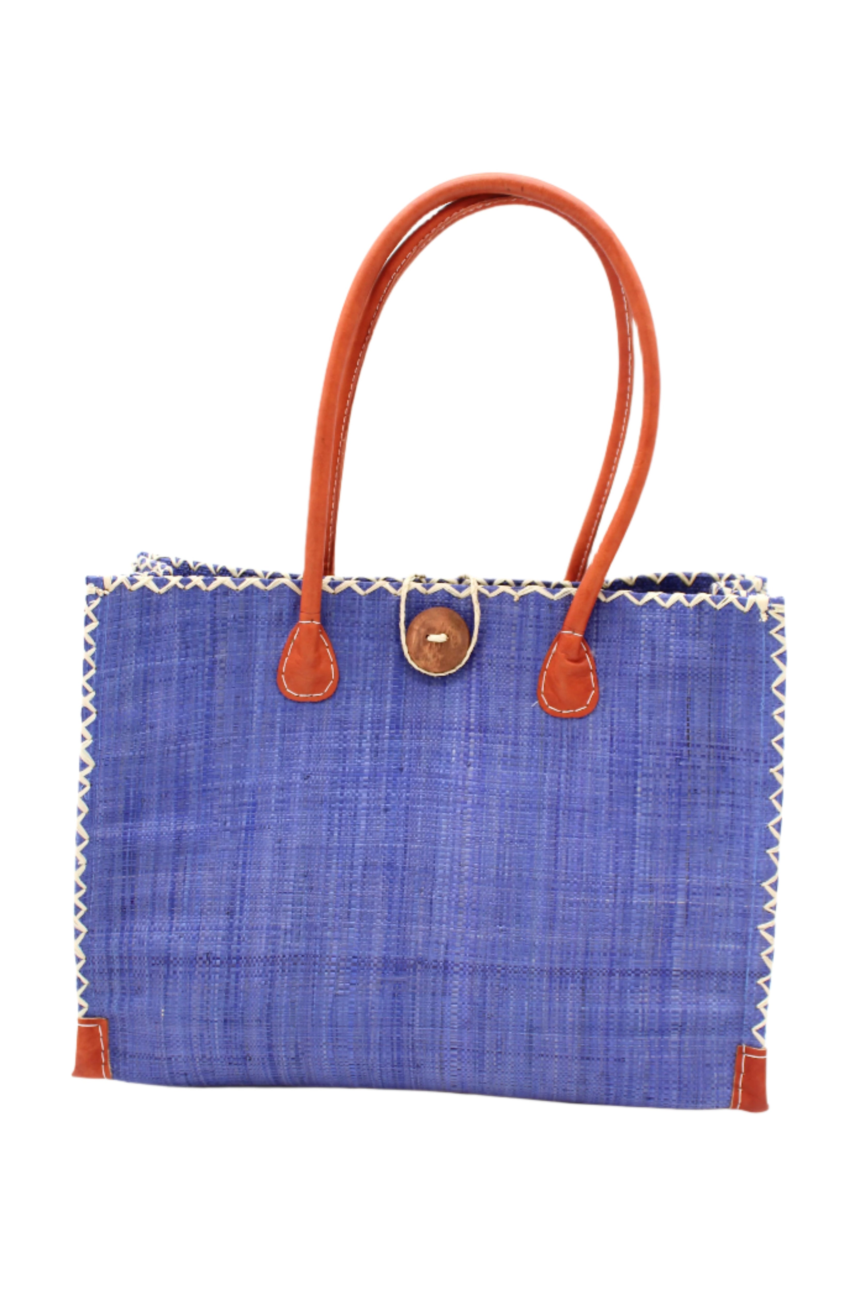 Zafran Straw Beach Bag with Plastic Liner handmade loomed raffia in a solid hue of Denim retro/light/blue with contrasting natural straw color cross stitch edge binding, wood button closure, and leather handles & feet plus assorted print plastic lining - Shebobo