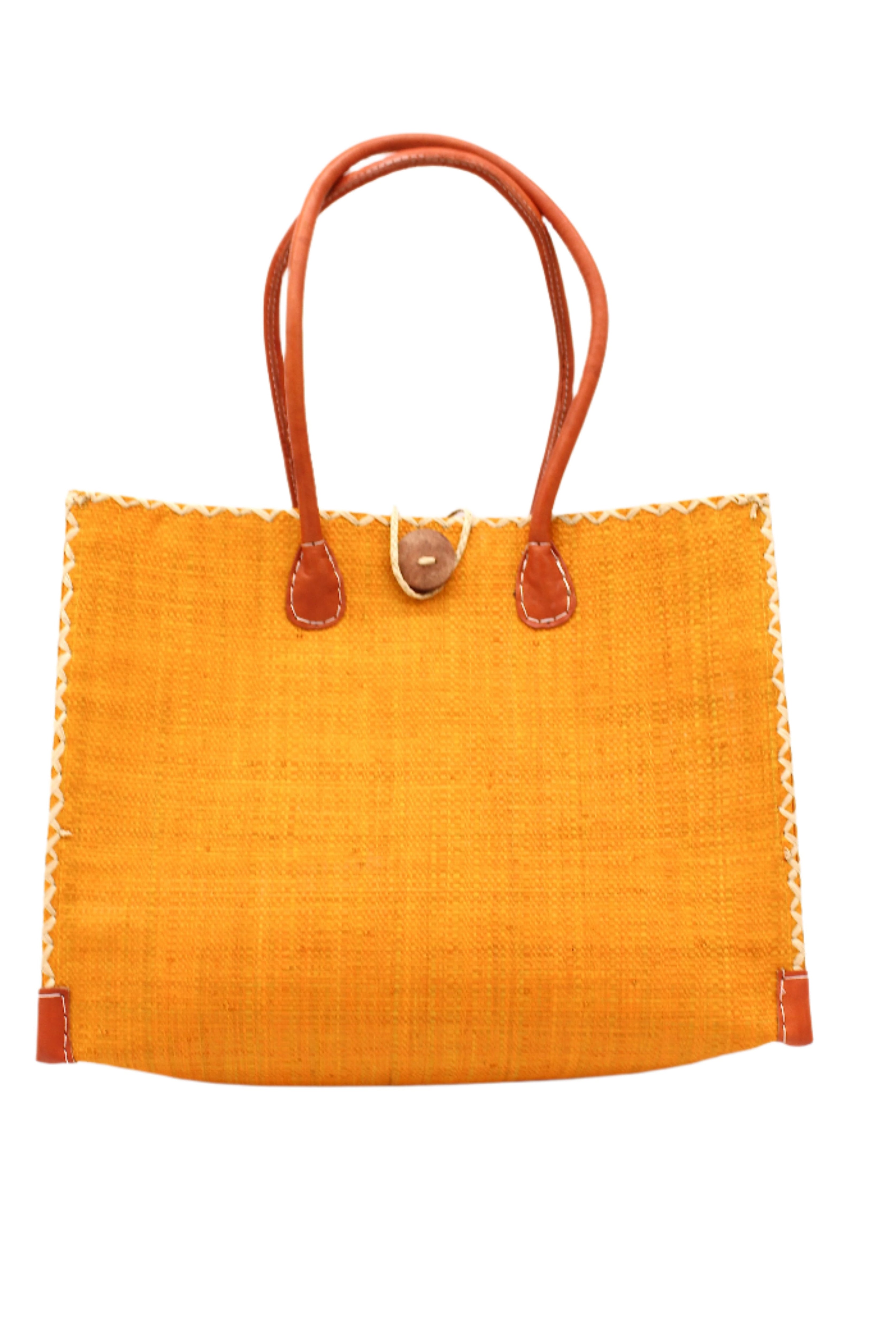 Zafran Straw Beach Bag with Plastic Liner handmade loomed raffia in a solid hue of saffron yellow/orange with contrasting natural straw color cross stitch edge binding, wood button closure, and leather handles & feet plus assorted print plastic lining - Shebobo