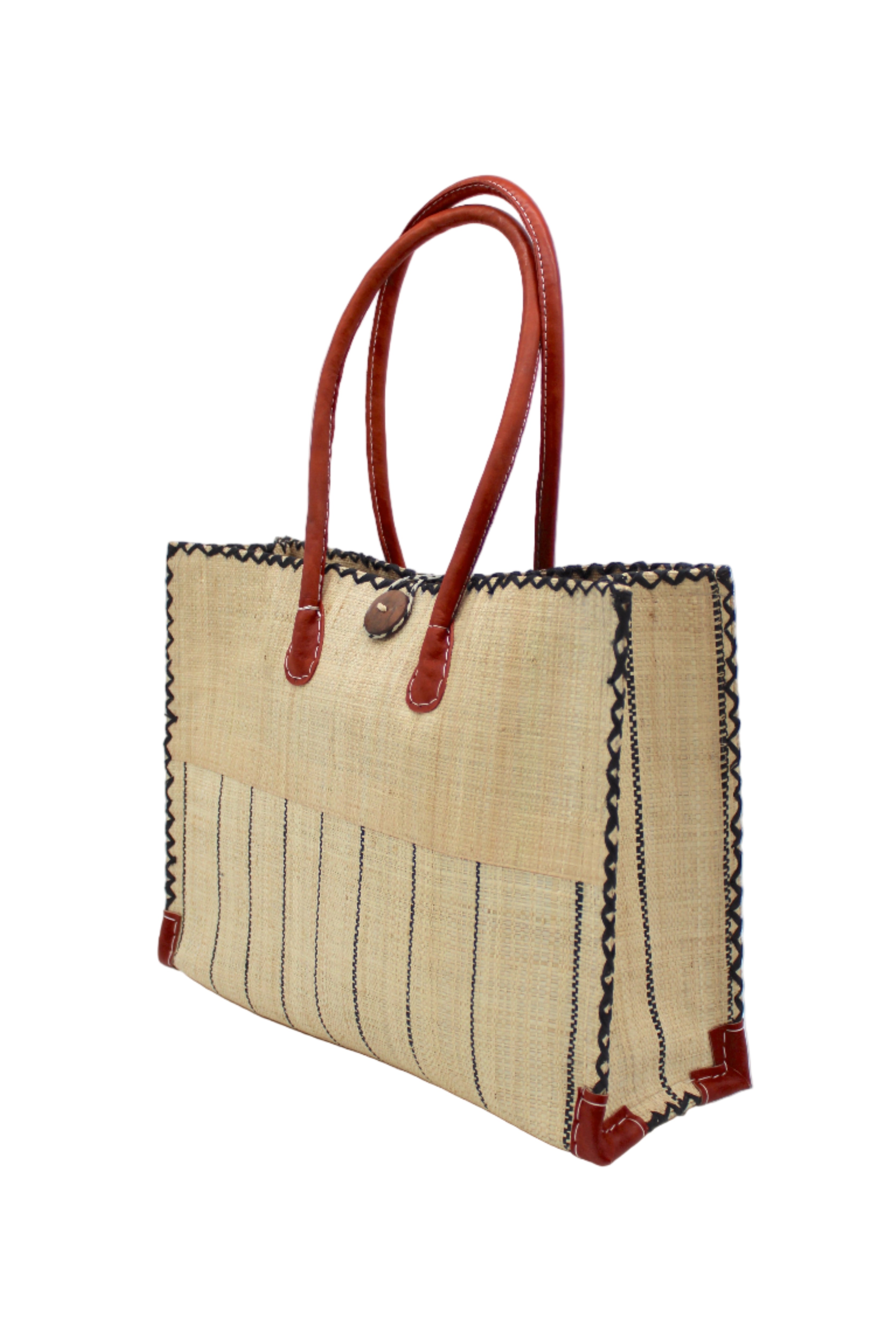 Side view Zafran Two Tone Wide Stripe Natural Pinstripe Straw Beach Bag handmade loomed raffia palm fiber in a solid hue of natural straw color on the top half of the bag and a multicolor multi-width vertical pinstripe stripe pattern with thin bands of black with wide bands of natural on the bottom half of the bag with leather handles and feet and matching crosshatch stitch edging shoulder bag - Shebobo