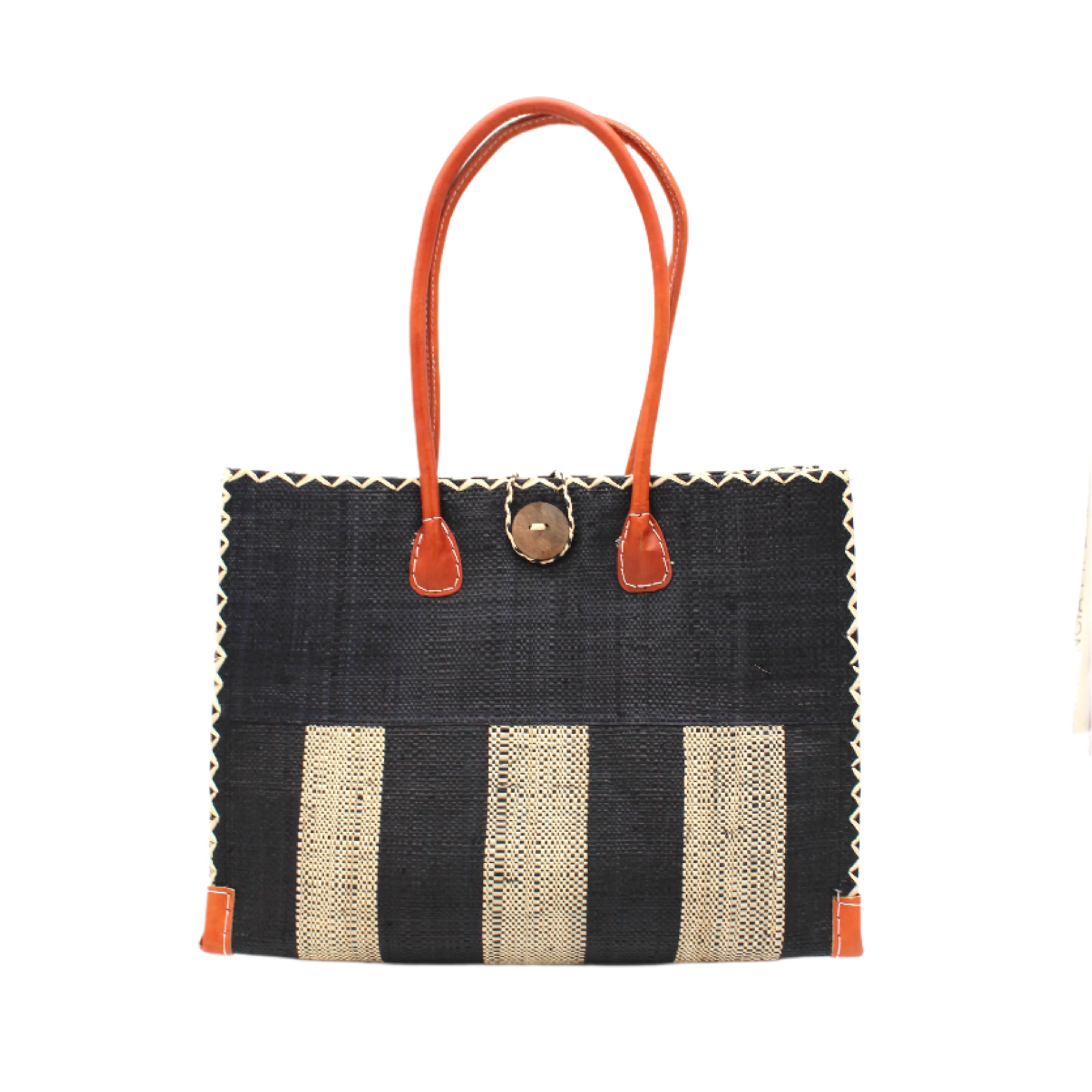 Zafran Two Tone Wide Stripe Black and Natural Straw Beach Bag handmade loomed raffia palm fiber in a solid hue of black on the top half of the bag and a two tone even width vertical wide stripe pattern of black and natural straw color on the bottom half of the bag with leather handles and feet and matching crosshatch stitch edging shoulder bag - Shebobo
