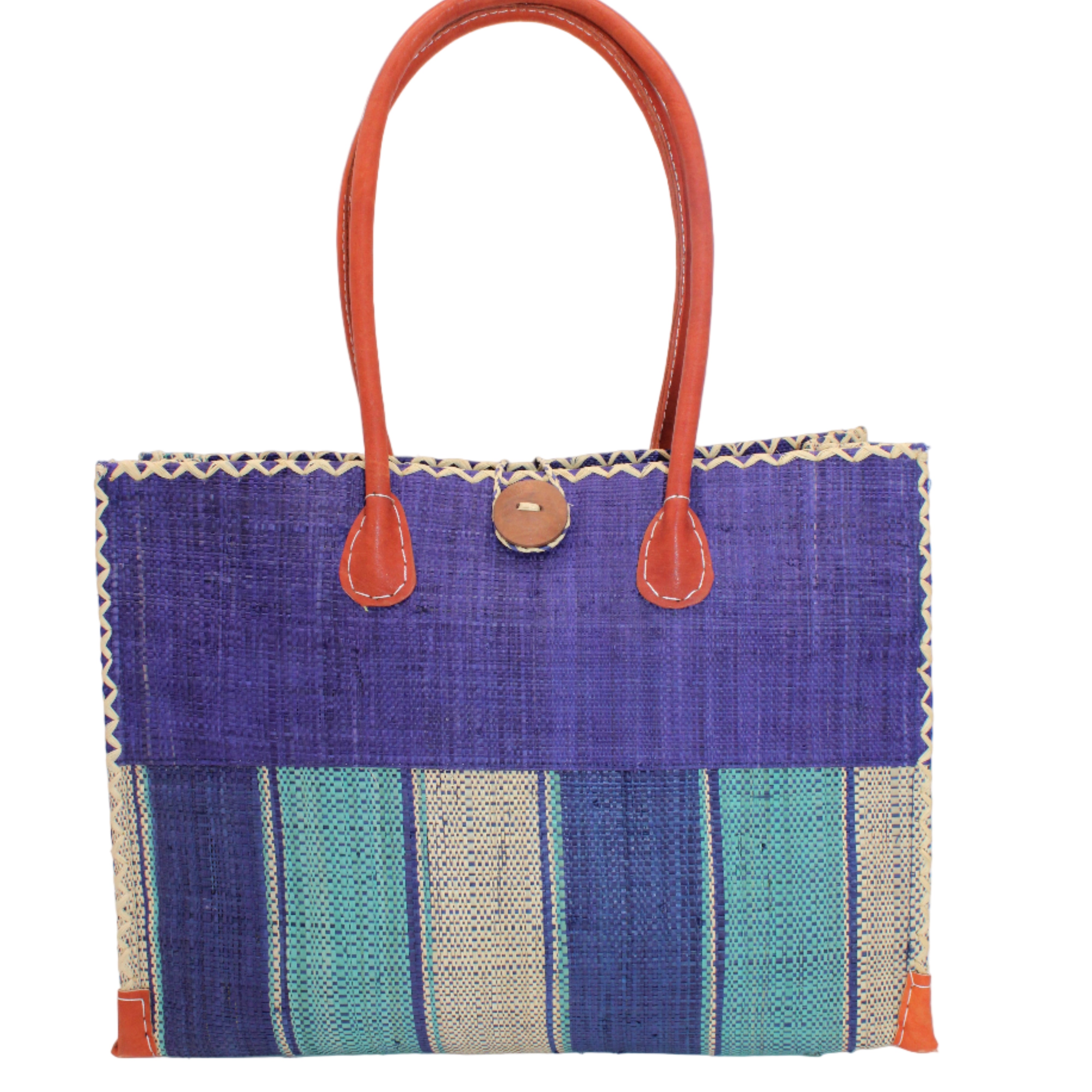 Zafran Two Tone Wide Stripe Blue Swirl Straw Beach Bag handmade loomed raffia palm fiber in a solid hue of dusk/navy/dark blue on the top half of the bag and a multicolor multi-width vertical stripe pattern of blue, turquoise, and natural straw color on the bottom half of the bag with leather handles and feet and matching crosshatch stitch edging shoulder bag - Shebobo