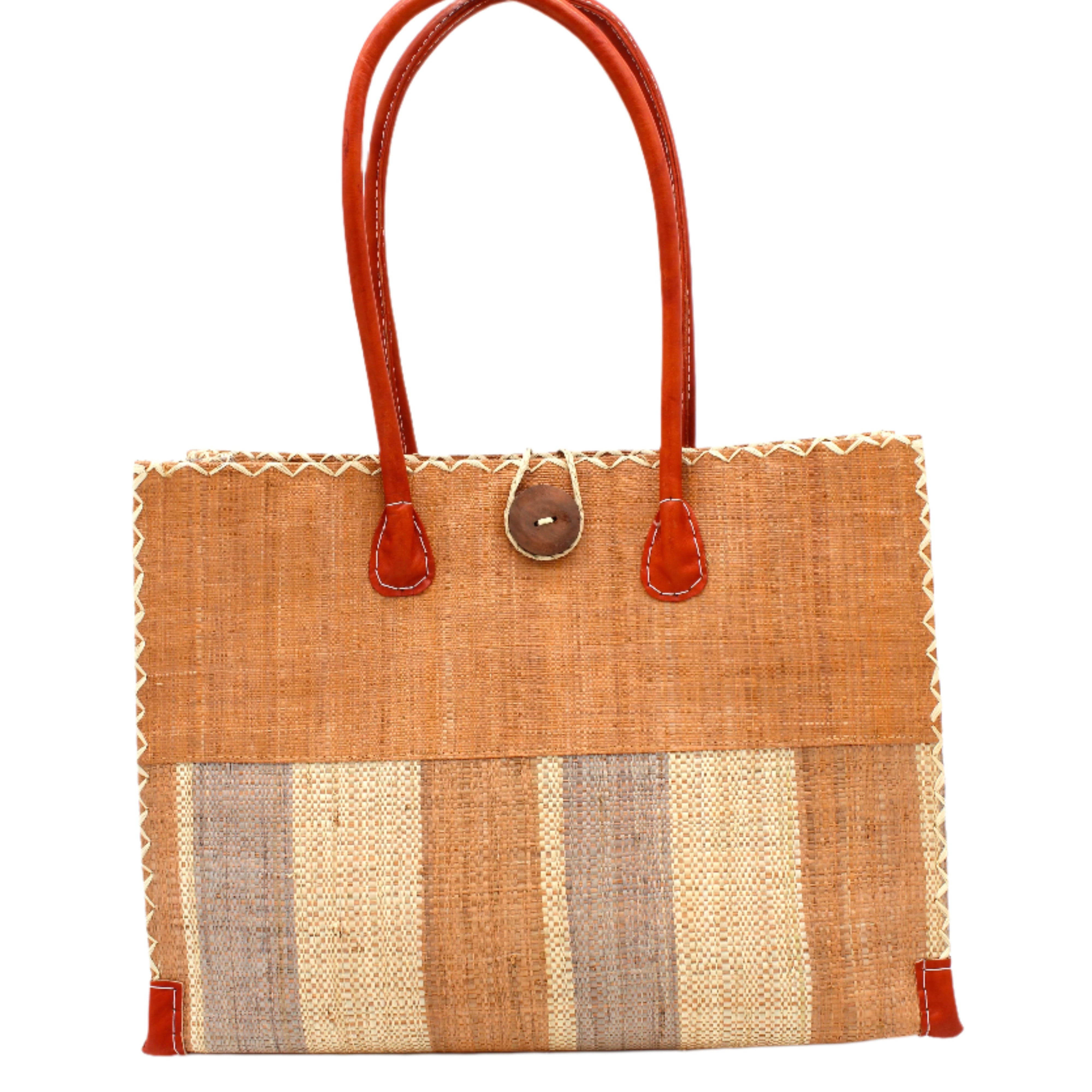 Zafran Two Tone Wide Stripe Blush Swirl Straw Beach Bag handmade loomed raffia palm fiber in a solid hue of blush orange/pink on the top half of the bag and a multicolor multi-width vertical stripe pattern of blush, grey, and natural straw color on the bottom half of the bag with leather handles and feet and matching crosshatch stitch edging shoulder bag - Shebobo