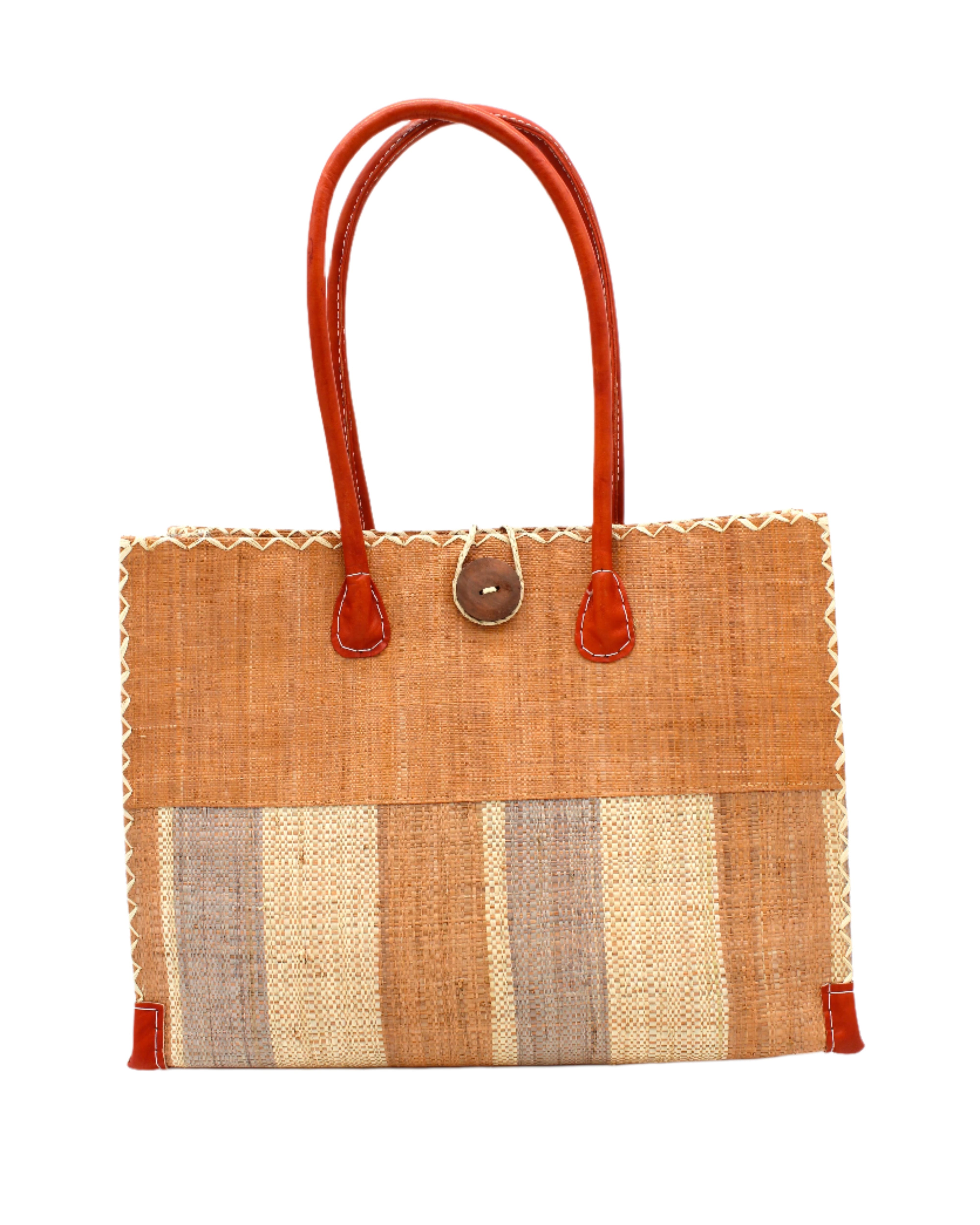 Zafran Two Tone Wide Stripe Blush Swirl Straw Beach Bag handmade loomed raffia palm fiber in a solid hue of blush orange/pink on the top half of the bag and a multicolor multi-width vertical stripe pattern of blush, grey, and natural straw color on the bottom half of the bag with leather handles and feet and matching crosshatch stitch edging shoulder bag - Shebobo