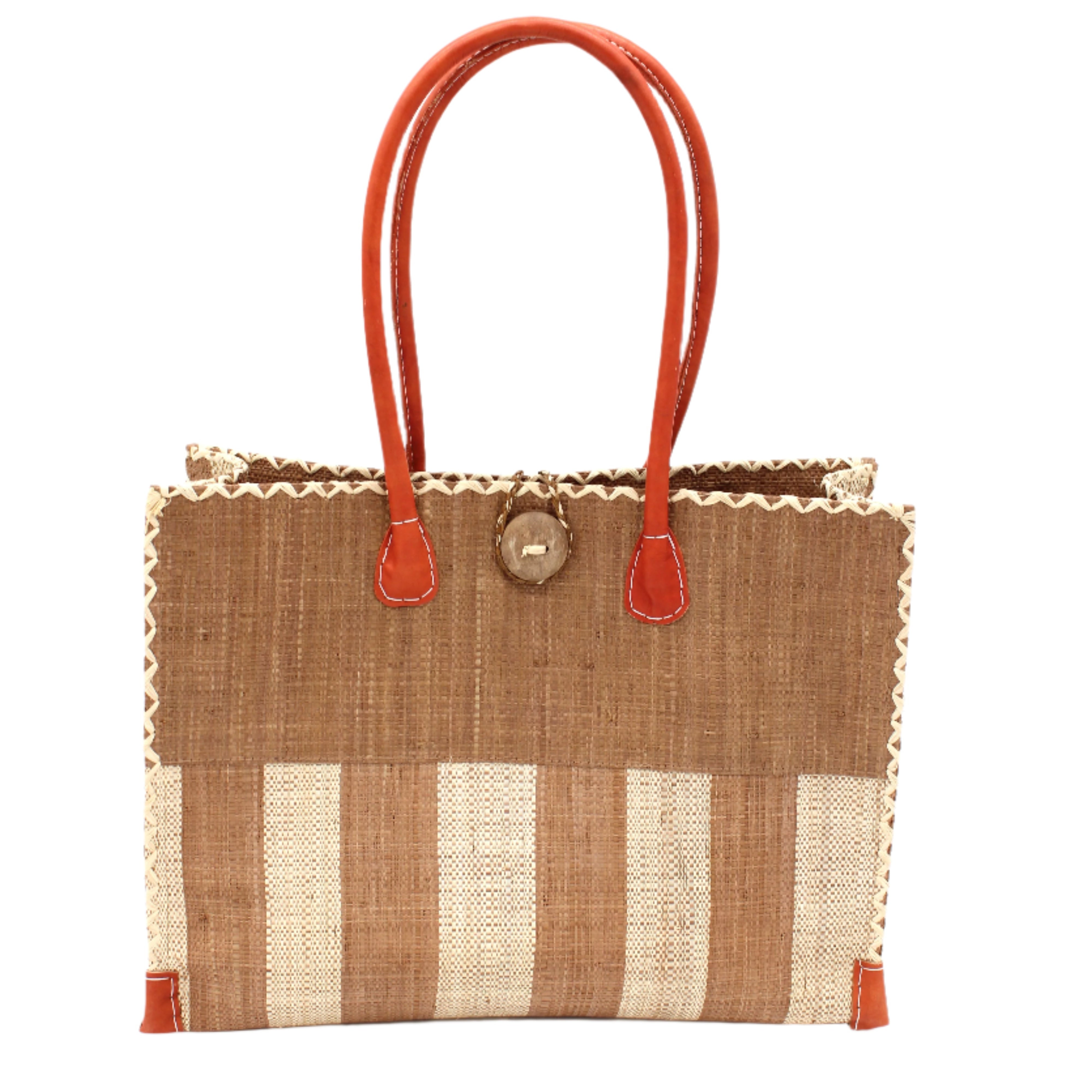 Zafran Two Tone Wide Stripe Cappuccino and Natural Straw Beach Bag handmade loomed raffia palm fiber in a solid hue of cappuccino light/brown/beige on the top half of the bag and a two tone even width vertical wide stripe pattern of cappuccino and natural straw color on the bottom half of the bag with leather handles and feet and matching crosshatch stitch edging shoulder bag - Shebobo
