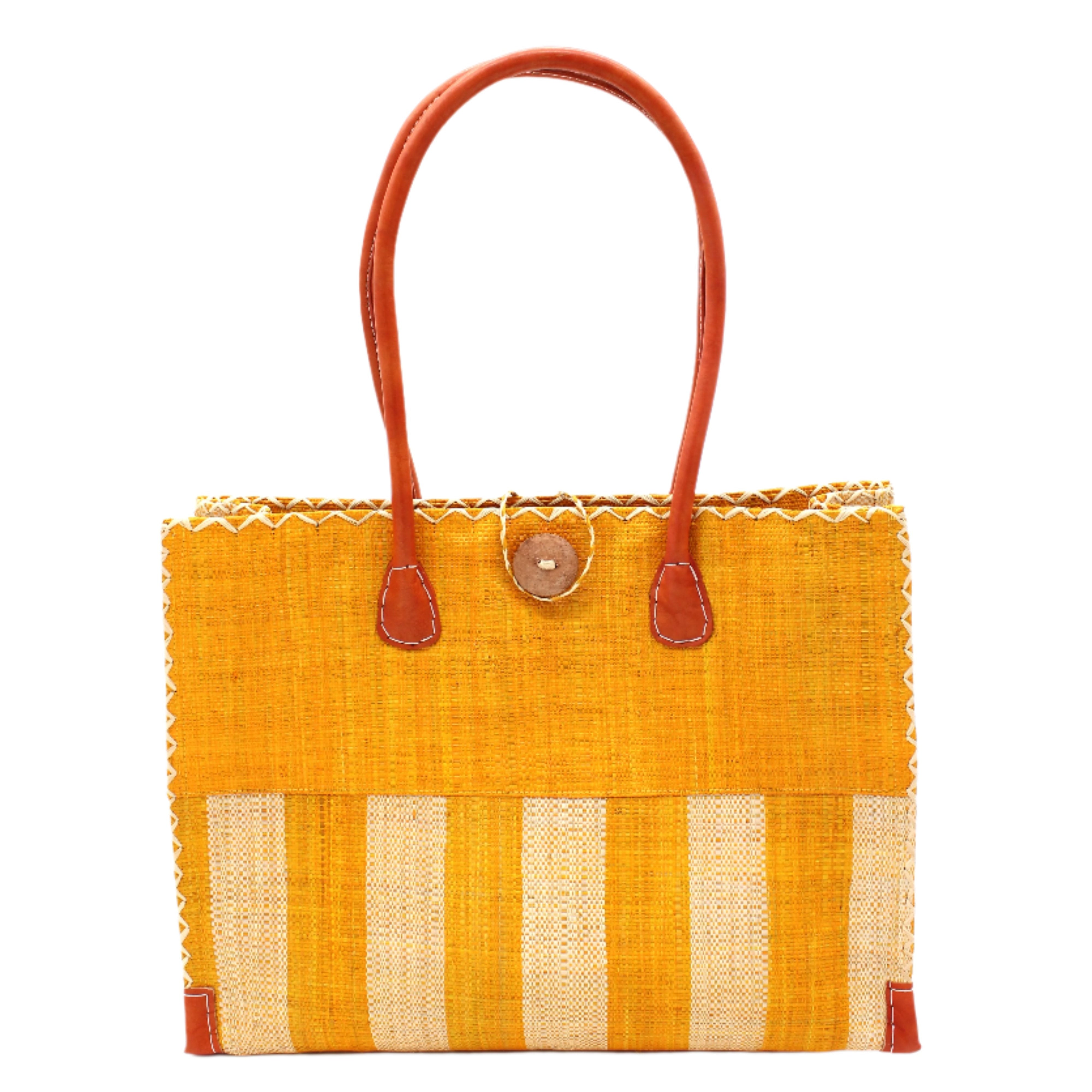 Zafran Two Tone Wide Stripe Saffron and Natural Straw Beach Bag handmade loomed raffia palm fiber in a solid hue of saffron yellow/orange on the top half of the bag and a two tone even width vertical wide stripe pattern of saffron and natural straw color on the bottom half of the bag with leather handles and feet and matching crosshatch stitch edging shoulder bag - Shebobo