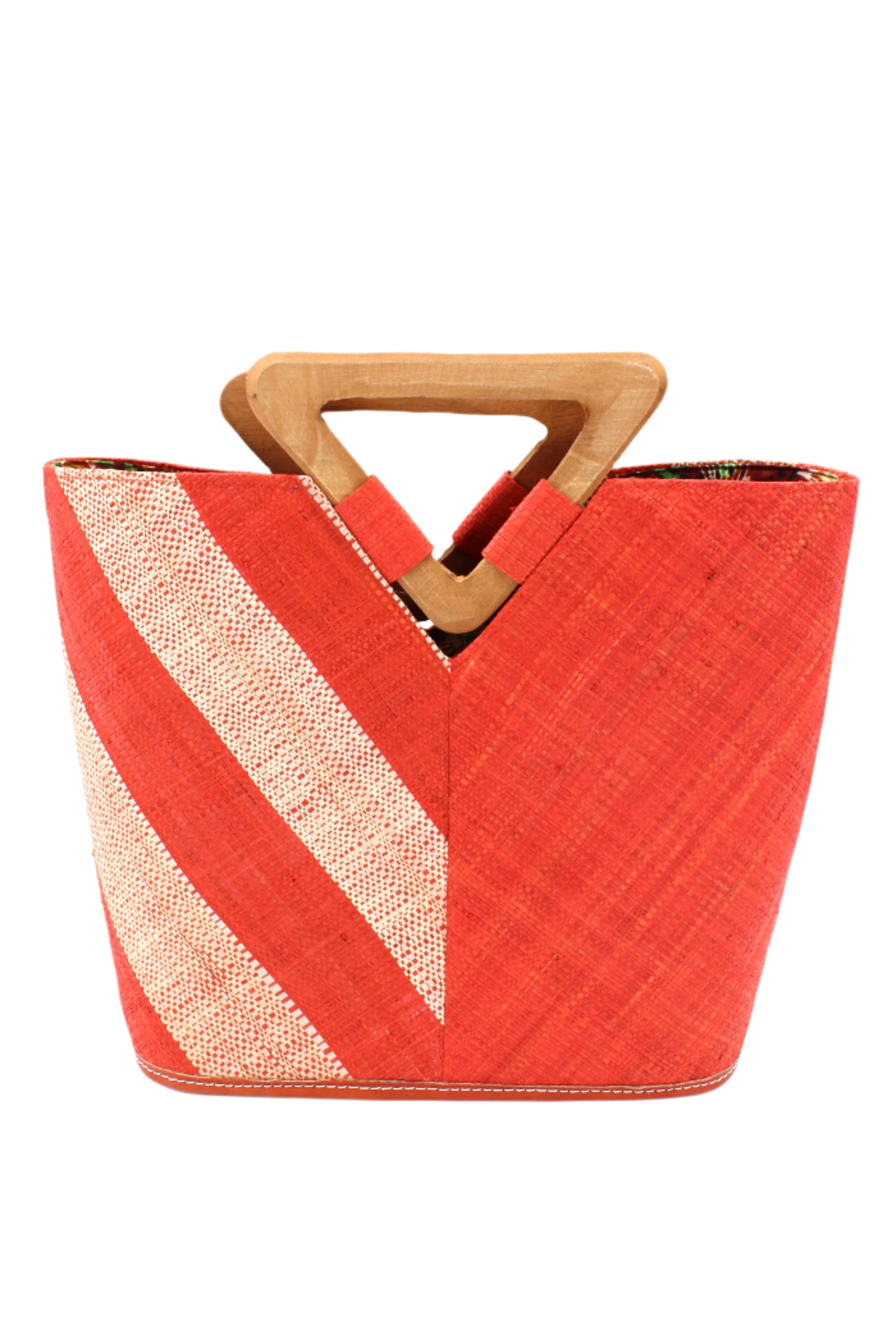 Zuki Two Tone Coral Straw Handbag With Wood Triangle Handle handmade loomed raffia palm fiber in a two tone pattern with the left half of the bag even width stripes of coral orange/red and natural straw color oriented as a diagonal stripe and the right half of the bag a solid hue of coral with carved wood handles - Shebobo