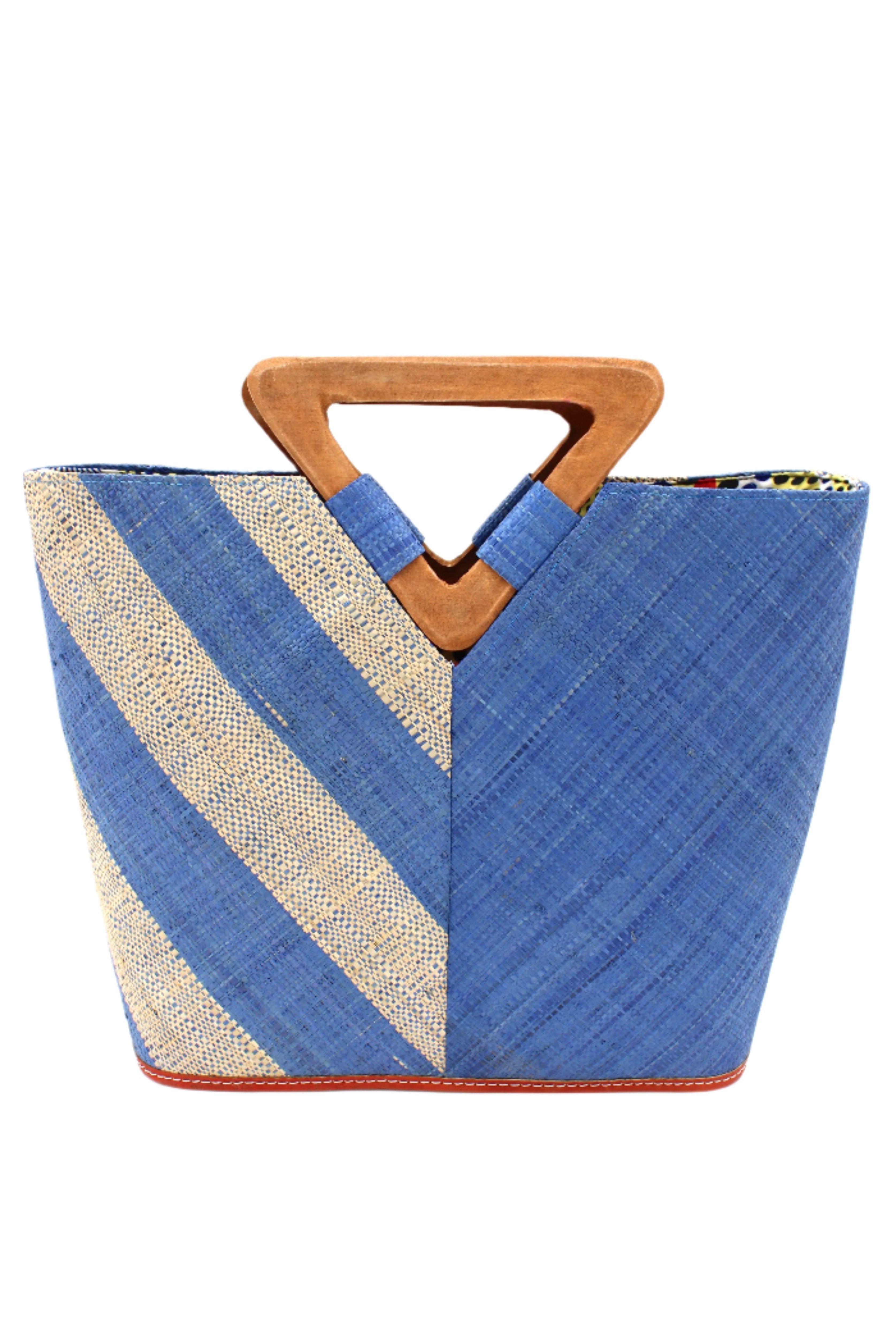 Zuki Two Tone Denim Straw Handbag With Wood Triangle Handle handmade loomed raffia palm fiber in a two tone pattern with the left half of the bag even width stripes of denim retro/light/blue and natural straw color oriented as a diagonal stripe and the right half of the bag a solid hue of denim with carved wood handles - Shebobo