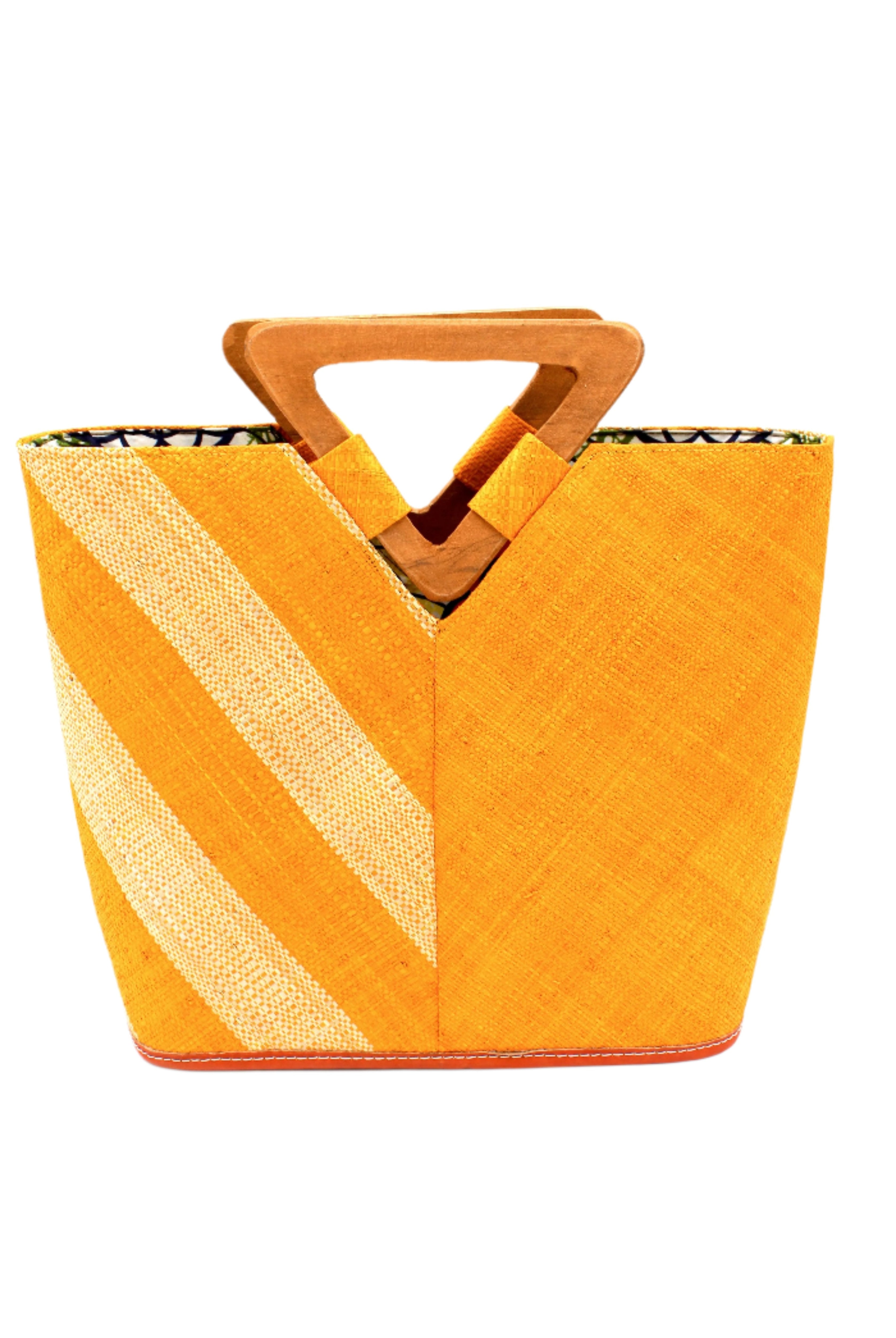 Zuki Two Tone Saffron Straw Handbag With Wood Triangle Handle handmade loomed raffia palm fiber in a two tone pattern with the left half of the bag even width stripes of saffron yellow/orange and natural straw color oriented as a diagonal stripe and the right half of the bag a solid hue of saffron with carved wood handles - Shebobo