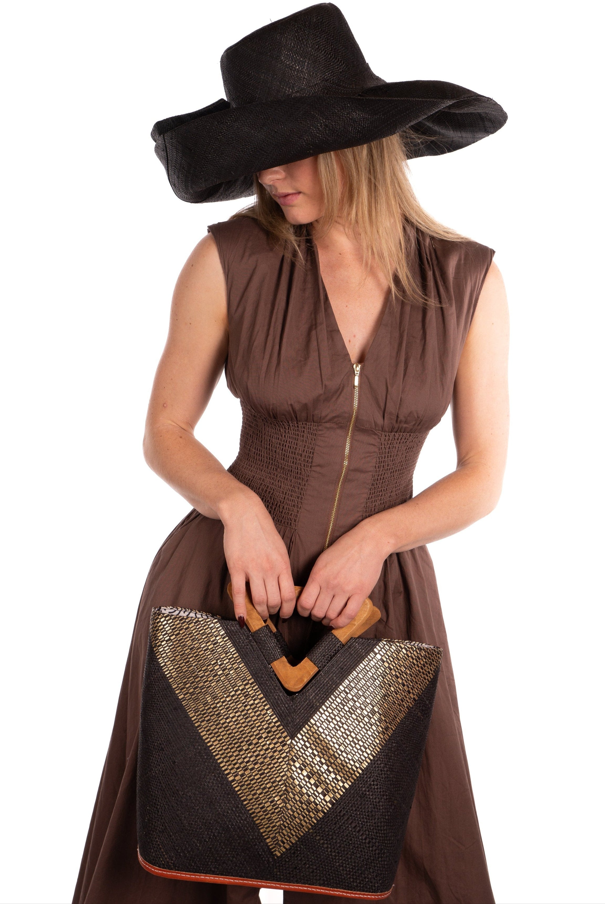 Zuki Wynwood Black Straw Handbag with Metallic Detailing & Wood Triangle Handle handmade loomed raffia palm fiber in a solid hue of black with incorporated vegan leather gold metallic strands in a V pattern across the front and back of the bag with assorted print African wax cloth liners and carved wooden triangle handle purse - Shebobo (with 5" & 7" Wide Brim Solid Color Straw Sun Hats with Big Bow)