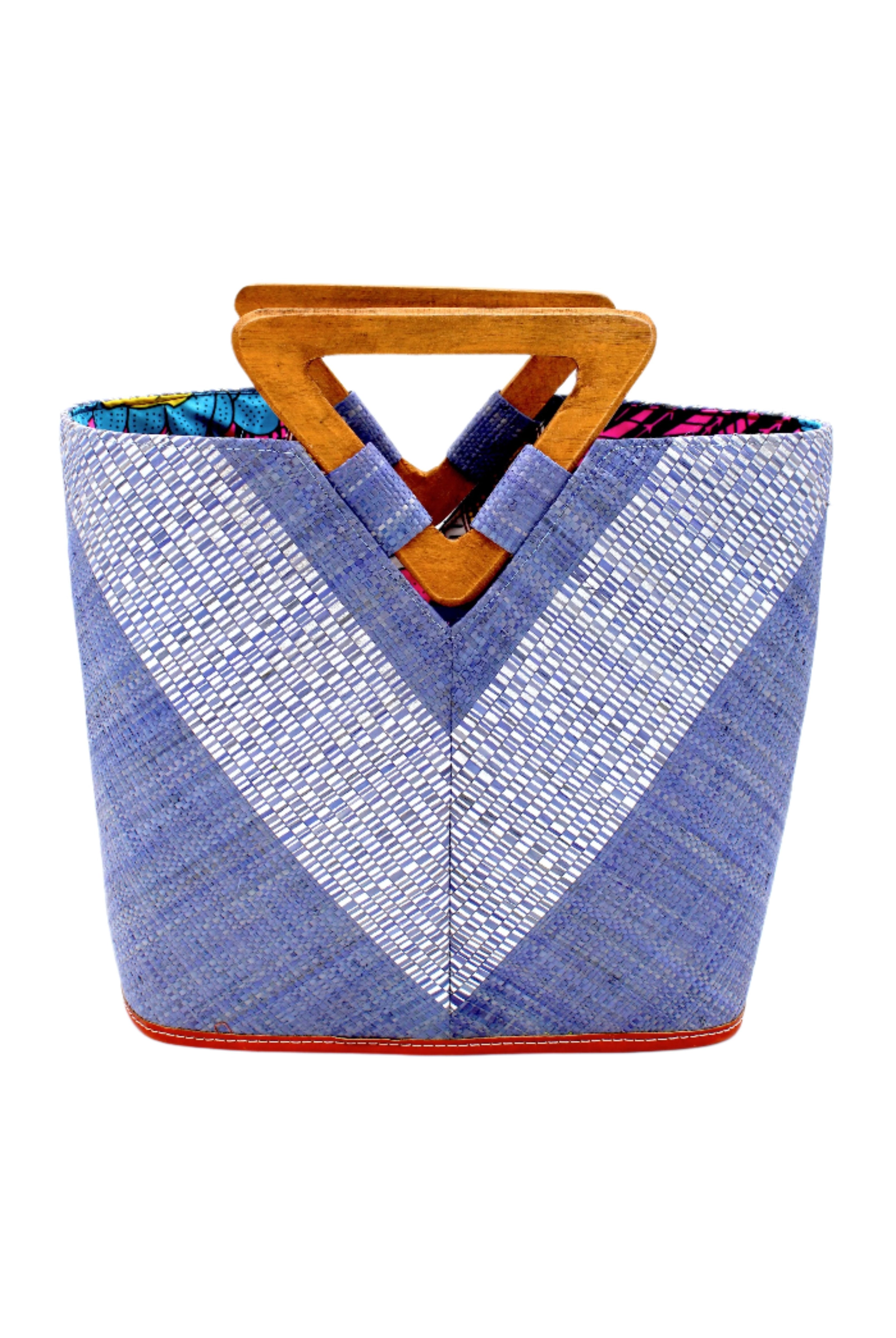 Zuki Wynwood Denim Straw Handbag with Metallic Detailing & Wood Triangle Handle handmade loomed raffia palm fiber in a solid hue of denim retro/light/blue with incorporated vegan leather silver metallic strands in a V pattern across the front and back of the bag with assorted print African wax cloth liners and carved wooden triangle handle purse - Shebobo