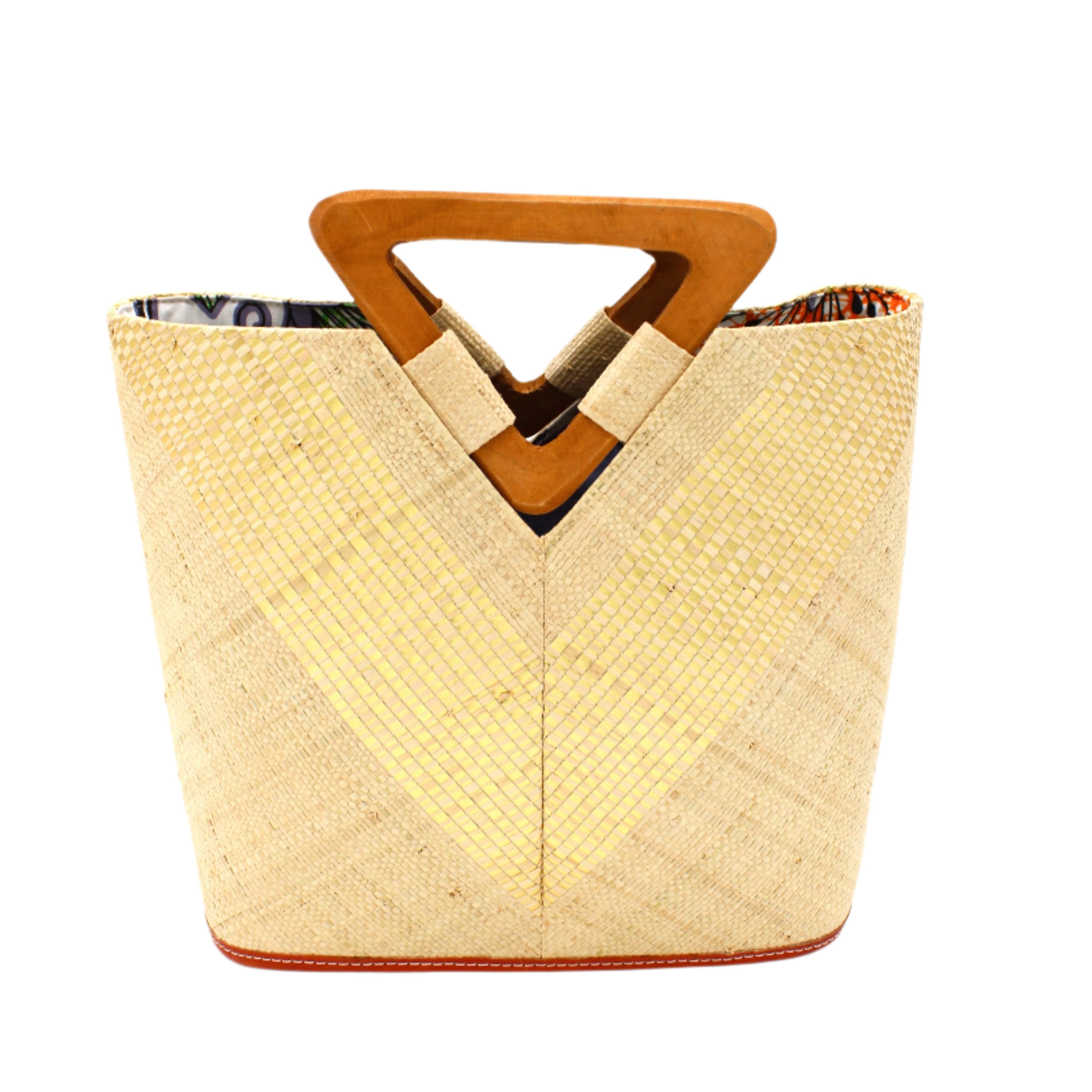 Zuki Wynwood Natural Straw Handbag with Metallic Detailing & Wood Triangle Handle handmade loomed raffia palm fiber in a solid hue of natural straw color with incorporated vegan leather gold metallic strands in a V pattern across the front and back of the bag with assorted print African wax cloth liners and carved wooden triangle handle purse - Shebobo