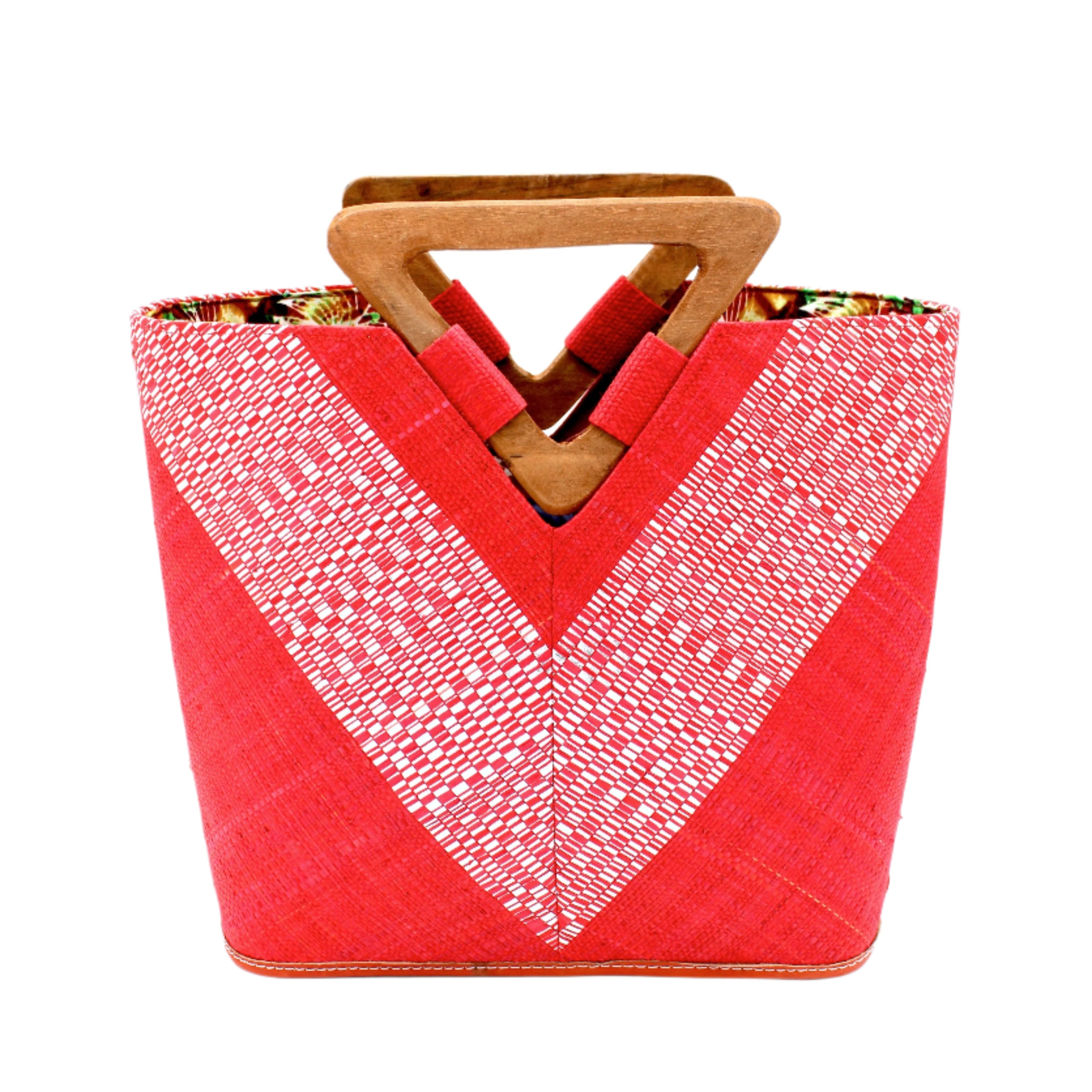Zuki Wynwood Red Straw Handbag with Metallic Detailing & Wood Triangle Handle handmade loomed raffia palm fiber in a solid hue of red with incorporated vegan leather silver metallic strands in a V pattern across the front and back of the bag with assorted print African wax cloth liners and carved wooden triangle handle purse - Shebobo
