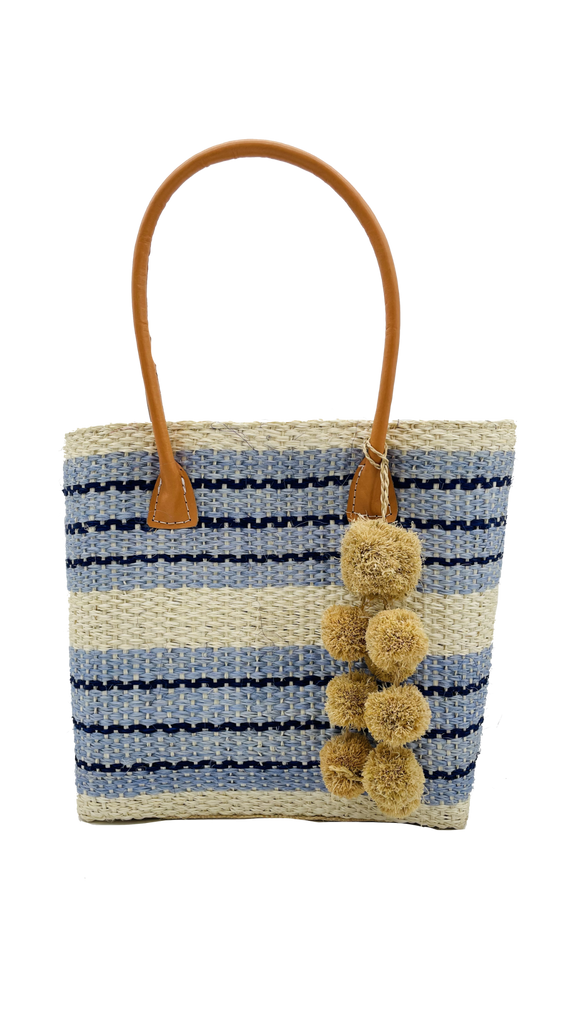 Imperial sisal woven basket bag natural straw color, navy, and light blue stripe pattern with raffia waterfall pompom charm embellishment handbag - Shebobo