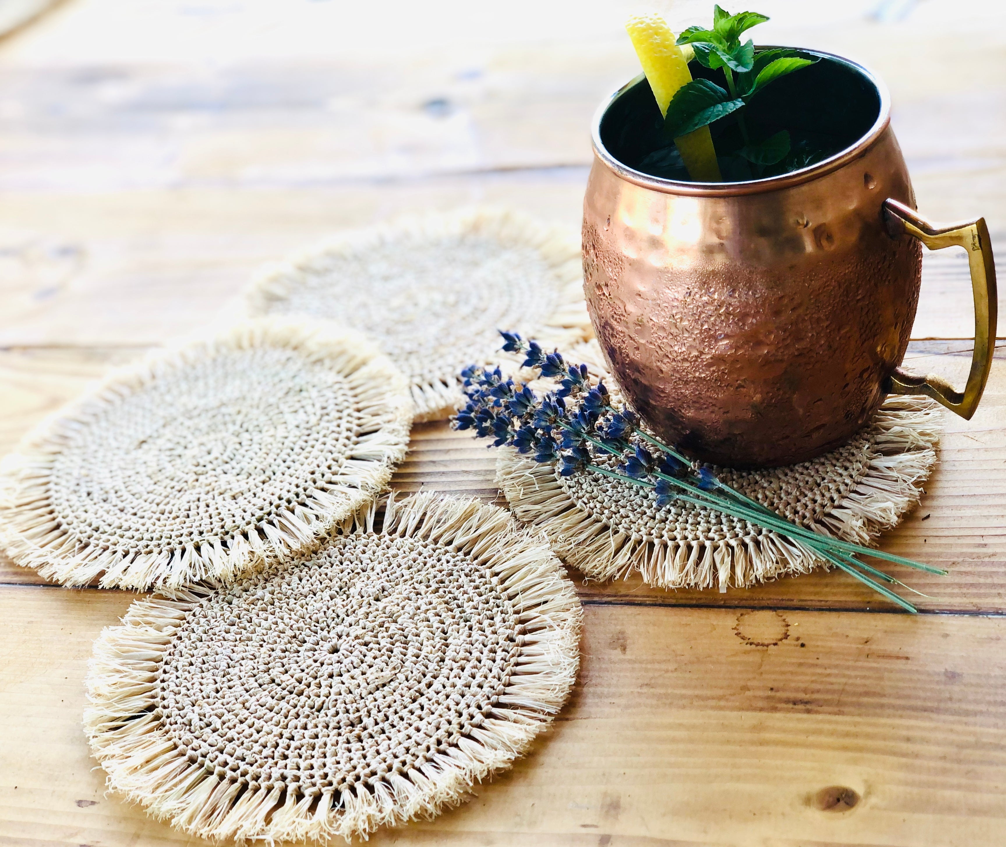 Imani Crochet Raffia Coasters set of four handmade natural raffia palm fiber crochet in a solid hue of natural straw color table setting protectors with brushed fringe edge with a spiral circular subtle texture - Shebobo