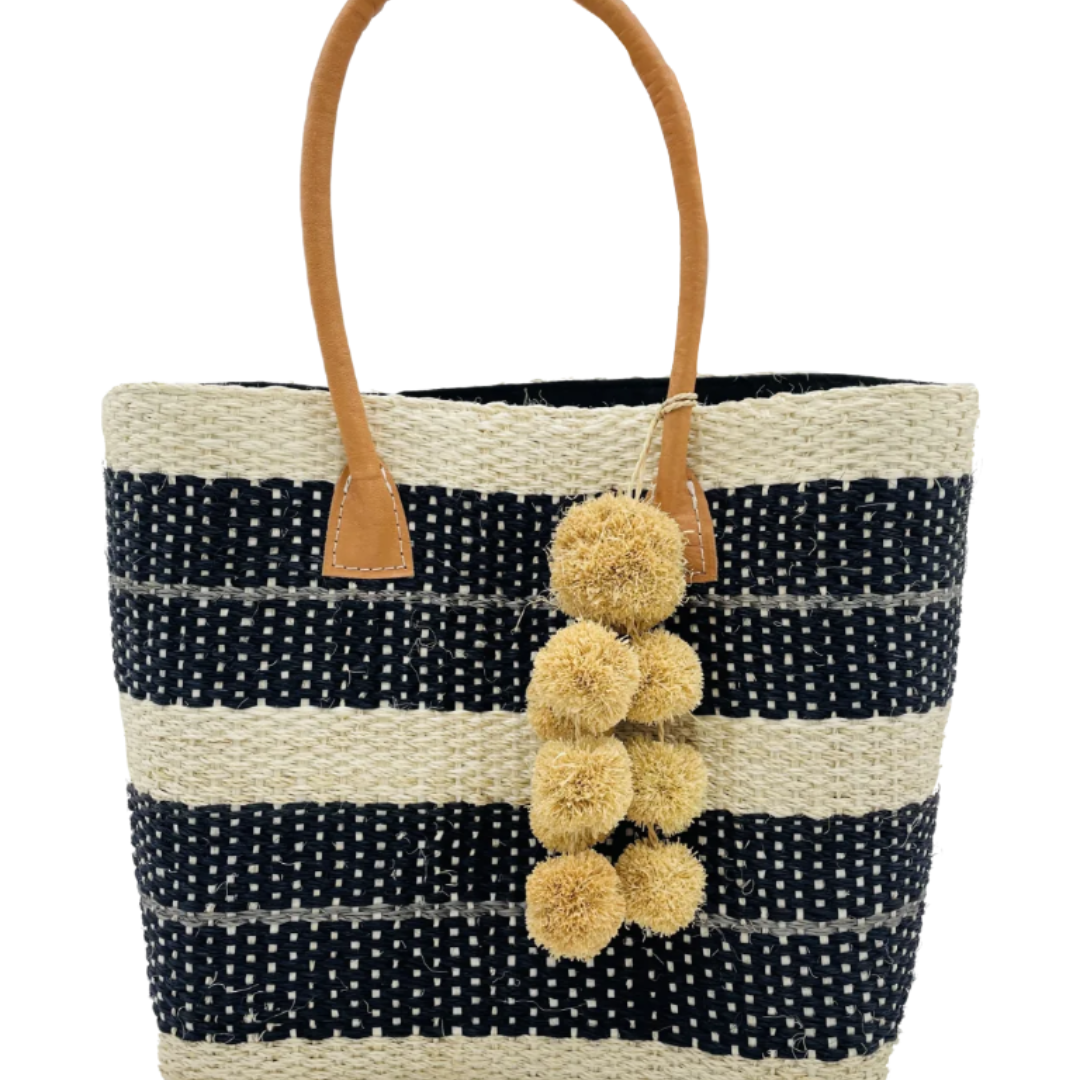Imperial sisal basket natural straw color, black, and grey horizontal multi-width stripe pattern handmade woven natural sisal fiber basket bag with raffia waterfall pompom charm embellishment handbag - Shebobo