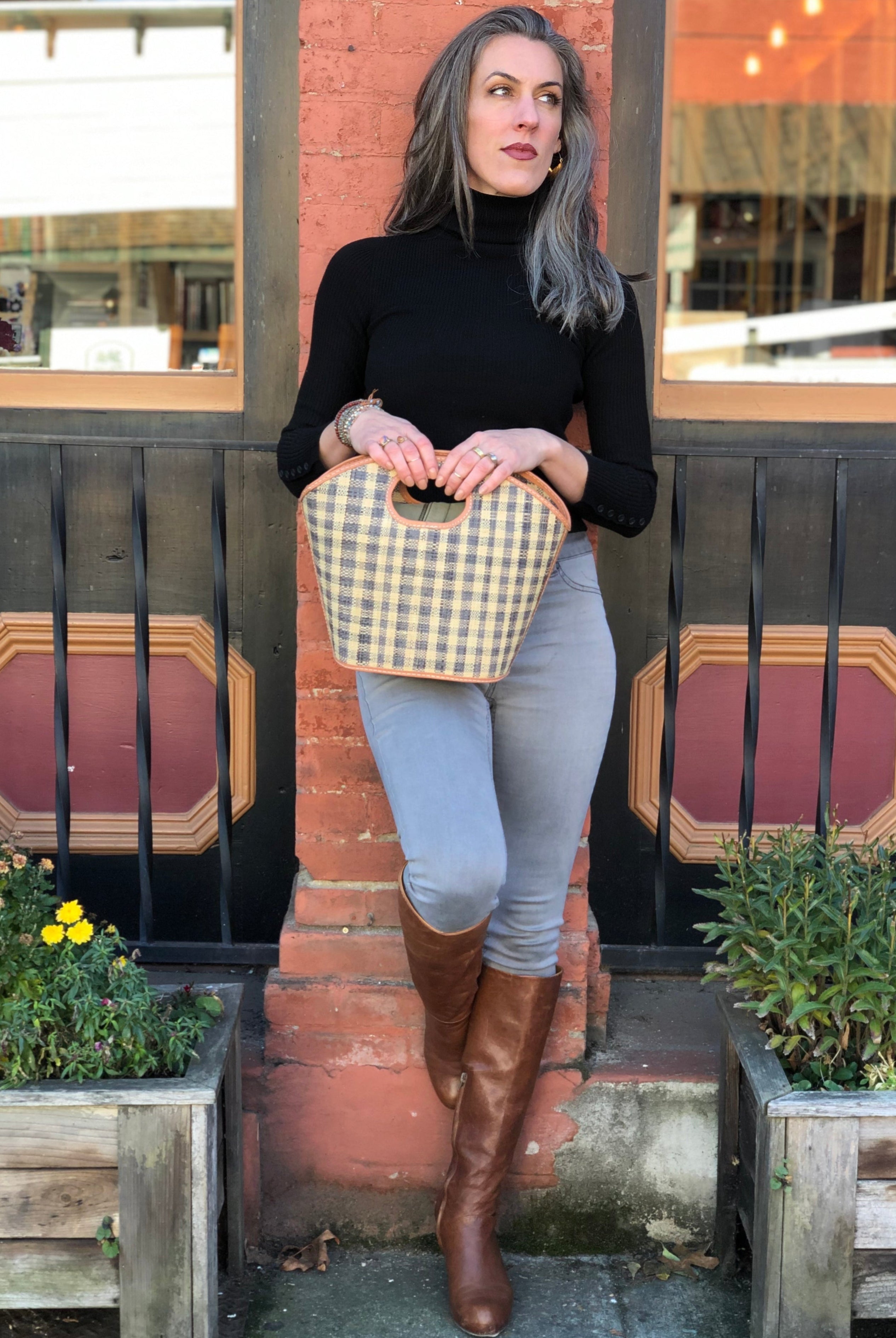 Model wearing Ricky Straw Bucket Handbag handmade loomed raffia in grey and natural gingham plaid pattern with leather finishes purse - Shebobo
