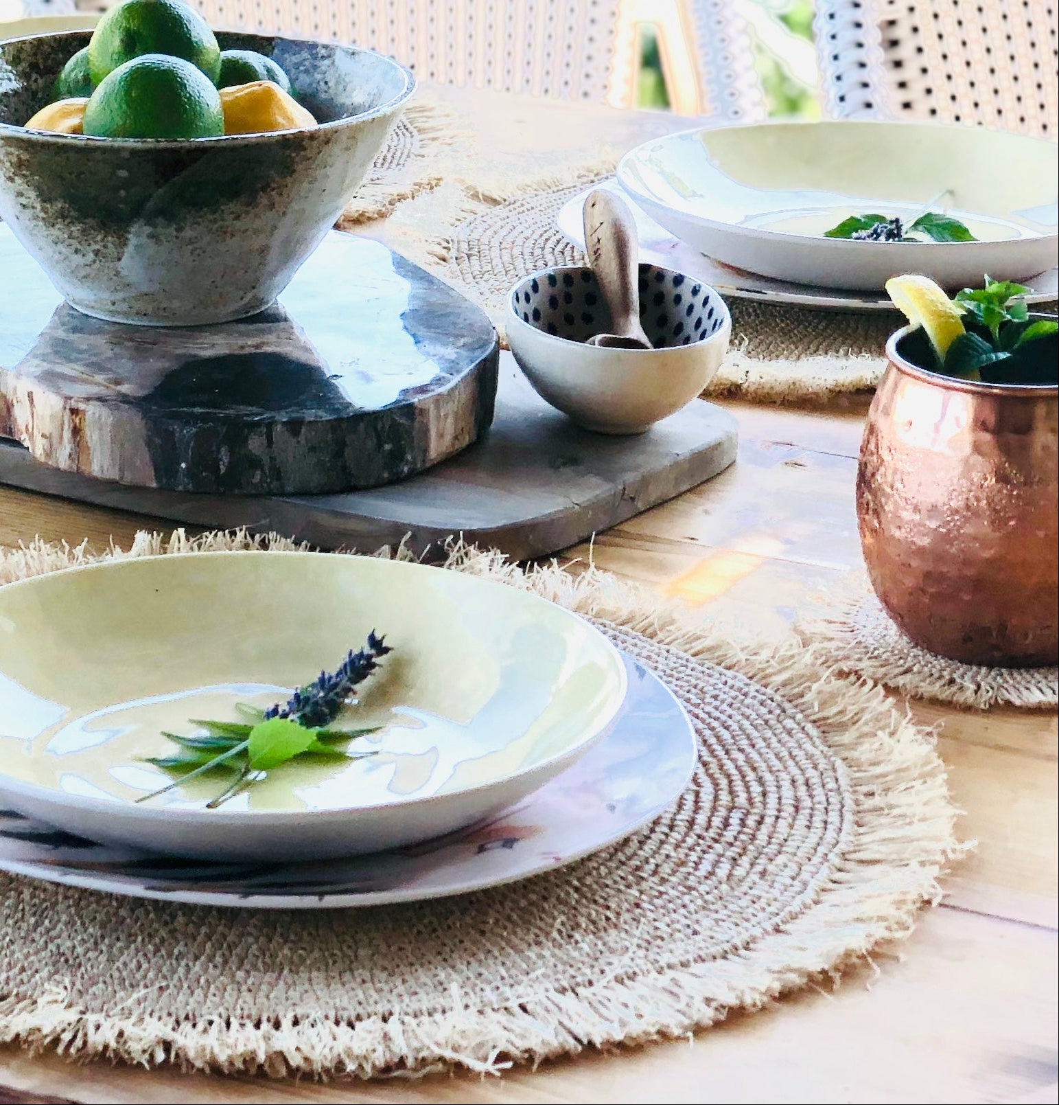 Imani Coasters - set of 4 hand crochet natural raffia with fringe shown with beautiful summertime table setting outdoor dinner party with matching crochet placemats - Shebobo