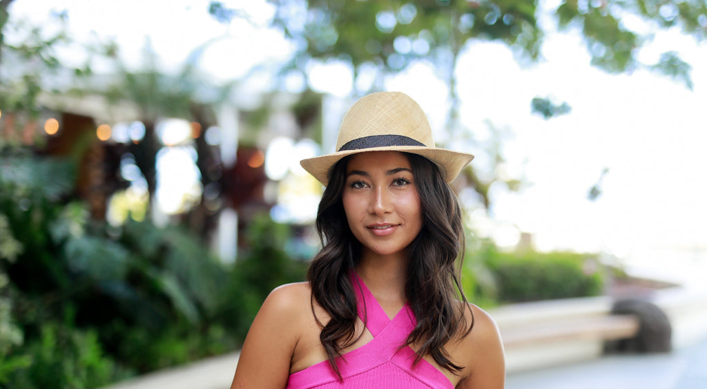Model wearing Fiston Fringe Natural - Unisex Fedora Straw Hat with Raw Edge handmade woven raffia strands in a solid hue of natural straw color with matching raw fringe edge embellishment and twisted raffia cord hat band - Shebobo