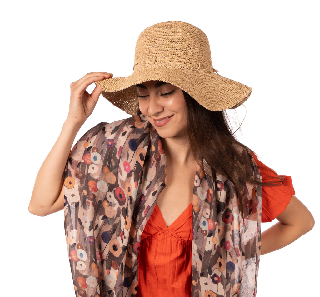 Model wearing Crochet Miramar Straw Sun Hat handmade woven raffia palm fiber in a subtle link pattered solid hue of natural straw color with matching adjustable braided hat band tie wide brim unisex panama style hat - Shebobo