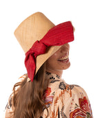 Model wearing Cara Big Bow Straw Hat Handmade loomed raffia straw hat solid natural bucket hat with large red bow - Shebobo