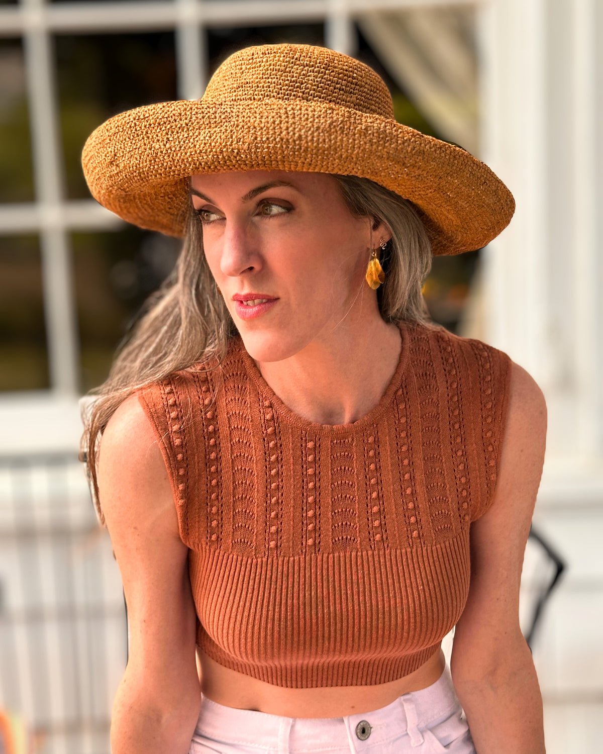 Model wearing Leor crochet straw hat handmade Blush orange/pink color raffia 3" brim packable straw hat with matching adjustable band - Shebobo