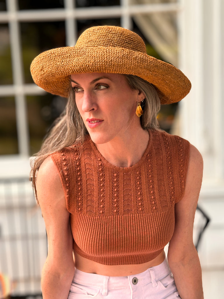 Model wearing Leor crochet straw hat handmade Blush orange/pink color raffia 3" brim packable straw hat with matching adjustable band - Shebobo