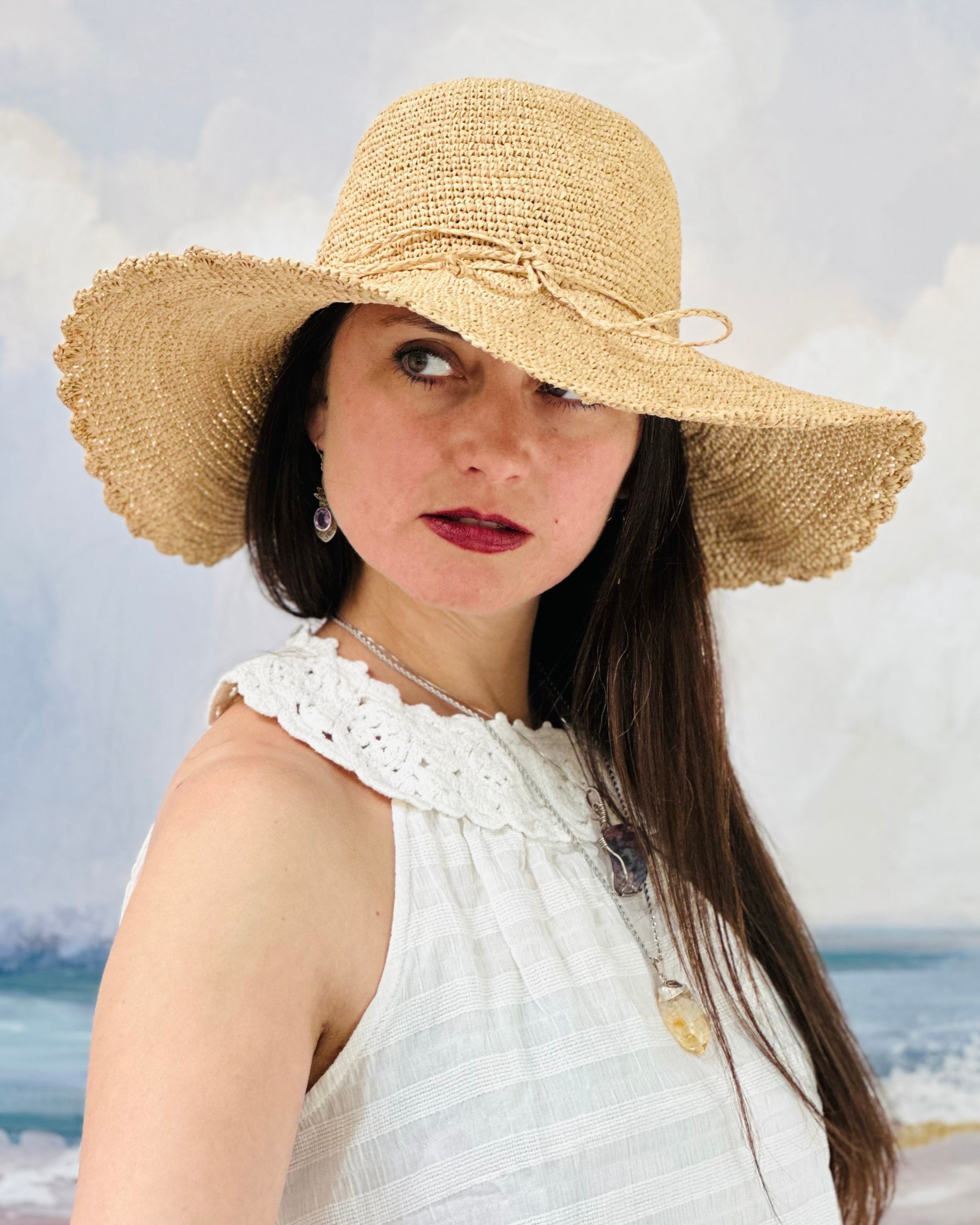 Model wearing 4" Brim Genevieve Natural Crochet Straw Sun Hat with Lace Weave Edge handmade raffia palm fiber crochet solid hue natural straw color rounded crown with detailed lace weave edge and matching adjustable hat band - Shebobo