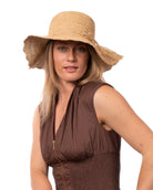 Model wearing 4" Brim Genevieve Natural Crochet Straw Sun Hat with Lace Weave Edge handmade raffia palm fiber crochet solid hue natural straw color rounded crown with detailed lace weave edge and matching adjustable hat band - Shebobo