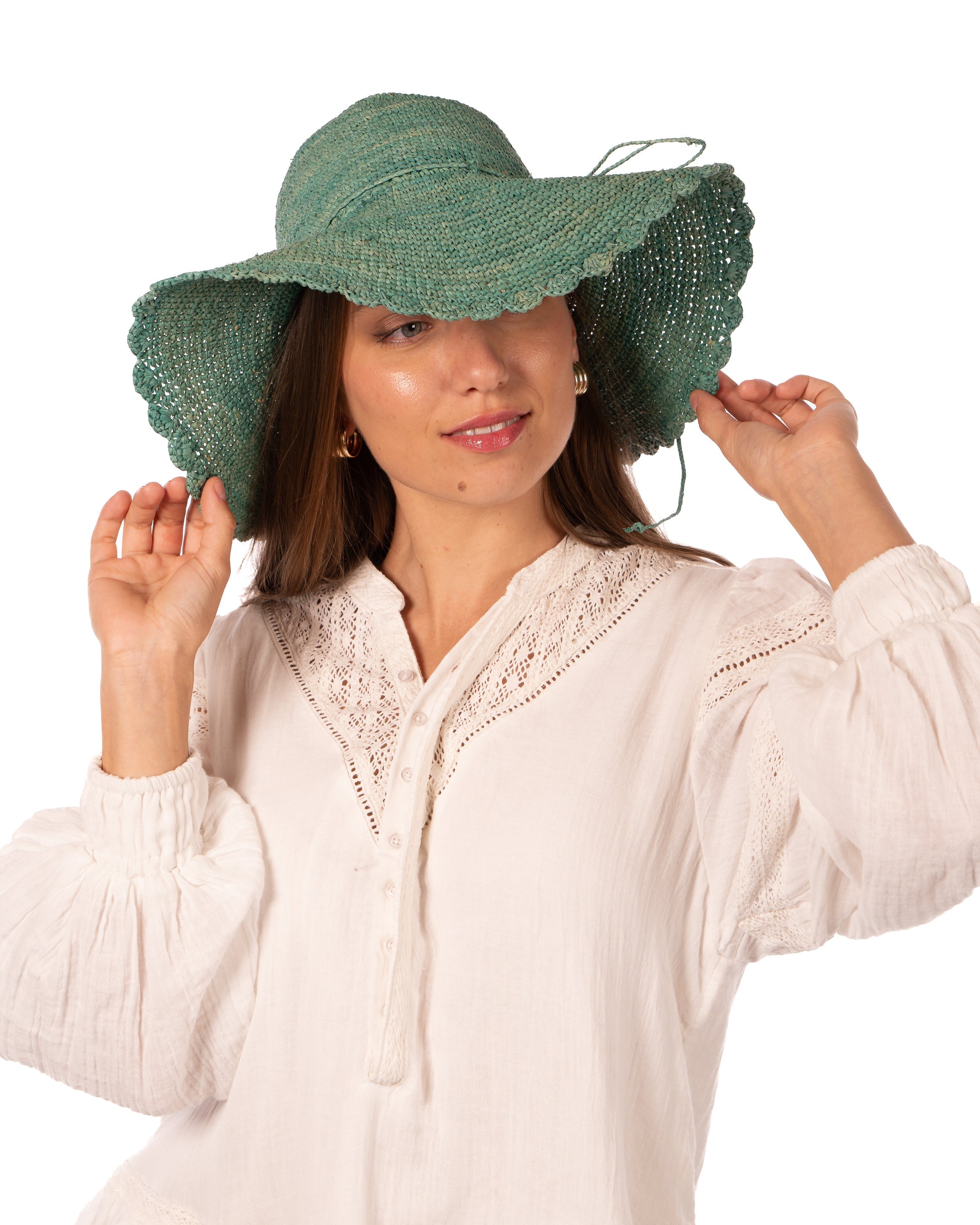 Model wearing 4" Brim Genevieve Seafoam Crochet Straw Sun Hat with Lace Weave Edge handmade raffia palm fiber crochet solid hue seafoam blue/green rounded crown with detailed lace weave edge and matching adjustable hat band - Shebobo