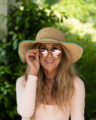 Model wearing 4" Brim Rachel Seafoam Crochet Straw Sun Hat handmade crochet natural raffia hat with seafoam blue/green edge and matching corded hat band - Shebobo