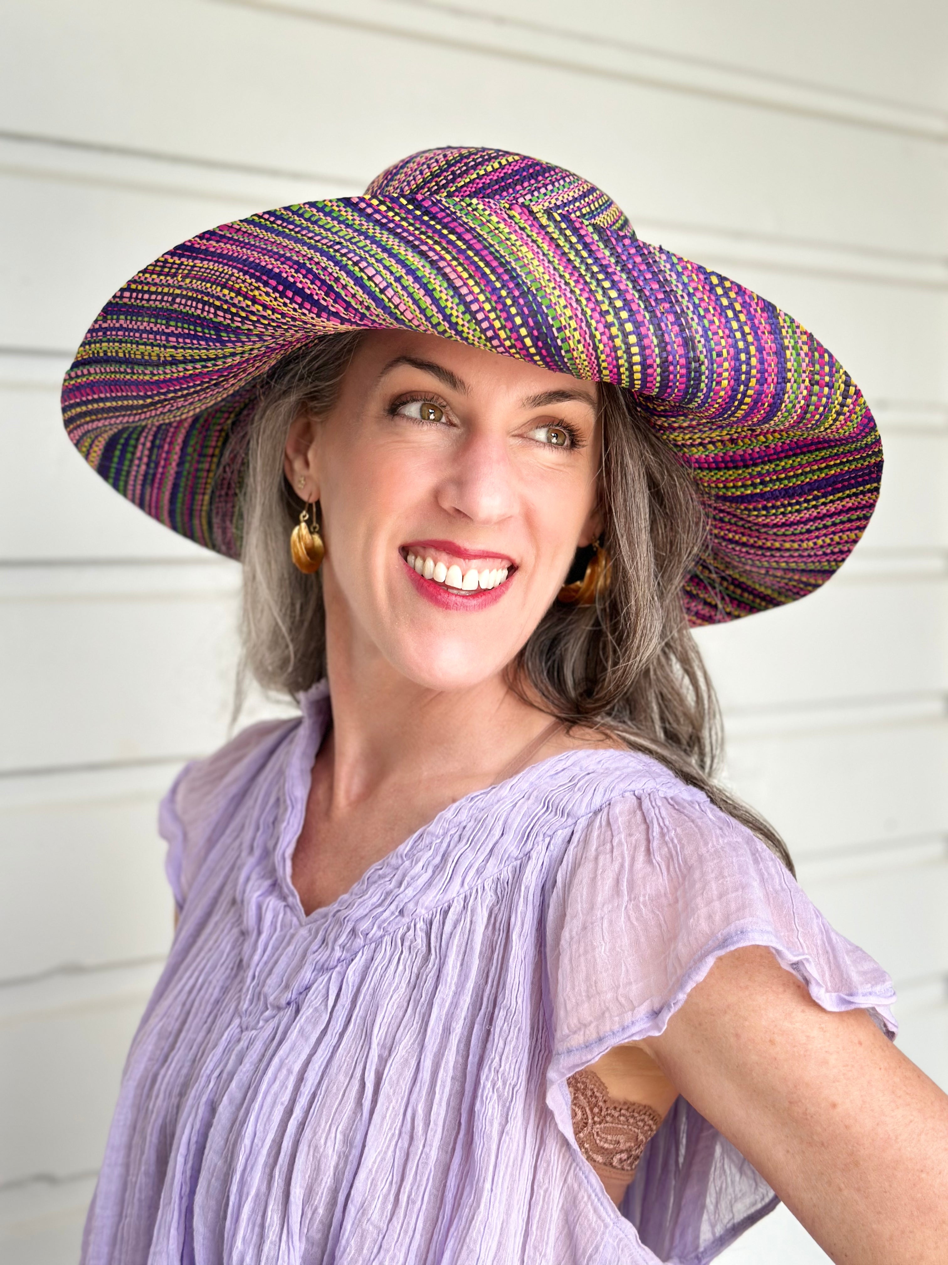 Model wearing 5" & 7" Wide Brim Orchid Multi Melange Packable Straw Sun Hat multicolor heather pattern of orchid purple, fuchsia pink, navy blue, green, yellow, pink, black, etc. - Shebobo
