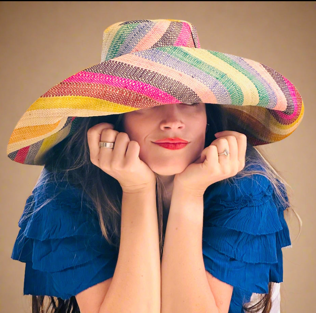 Model wearing 5" & 7" Wide Brim Lollipop Multicolor Stripes Packable Straw Sun Hat Handmade loomed raffia in multi width bands of saffron yellow, fuchsia pink, turquoise blue, black, grass green, seafoam blue/green, pink, yellow, orange, blue, red, whiskey brown, natural straw color, etc. create a swirl pattern - Shebobo