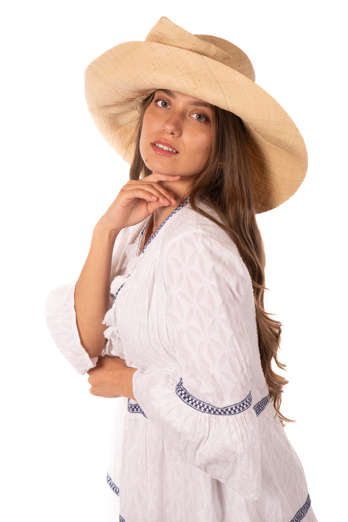 Model wearing 7" Wide Brim Solid Color Straw Sun Hats with Big Bow handmade loomed natural raffia straw fiber in a solid hue of natural straw color with matching oversized big bow embellishment hat band - Shebobo