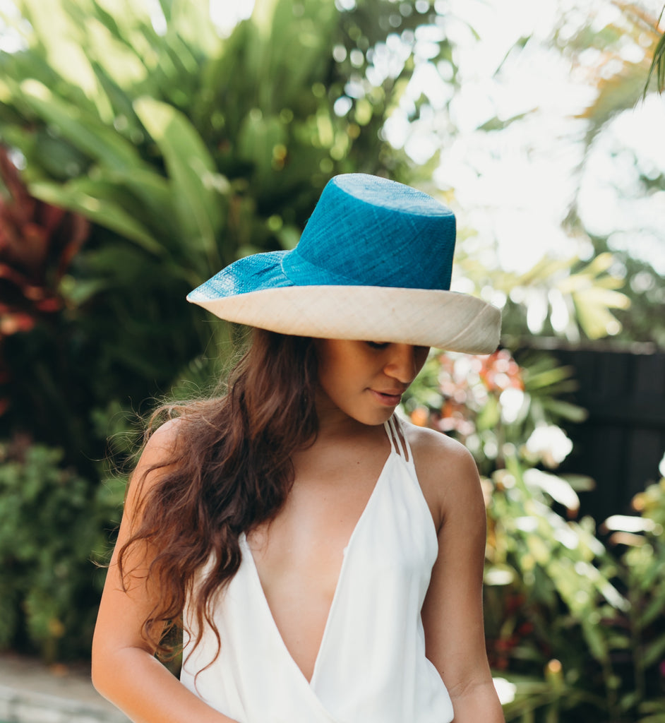 Model wearing 5 inch wide brim handmade teal dark/blue/green top half and natural straw color bottom half two tone loomed raffia sun protection packable lightweight straw hat - Shebobo