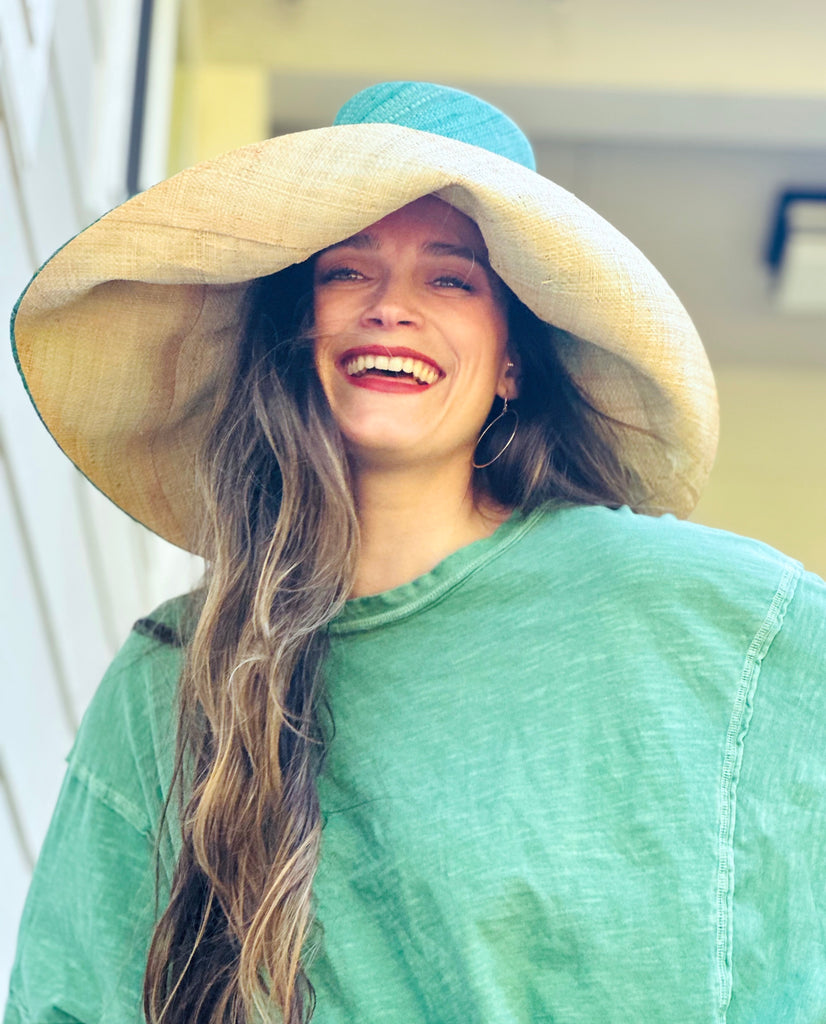 Model wearing 5 inch or 7 inch wide brim handmade seafoam blue/green top half and natural straw color bottom half two tone loomed raffia sun protection packable lightweight straw hat - Shebobo