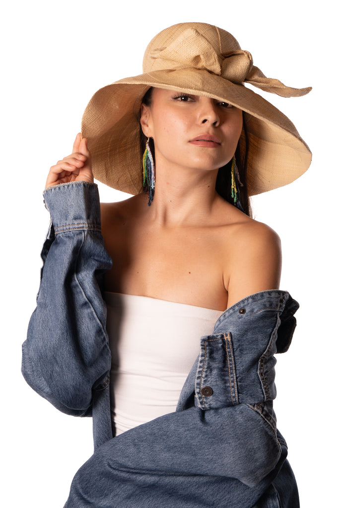 Model wearing 5" Wide Brim Solid Color Straw Sun Hats with Big Bow handmade loomed natural raffia straw fiber in a solid hue of natural straw color with matching oversized big bow embellishment hat band - Shebobo