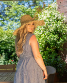 Model wearing Karin Crochet & Macrame Natural Raffia Knotted Straw Sun Hat Lightweight Breathable with Fringe Edge geometric star or sunburst design brim and geometric knotted diamond pattern top - Shebobo