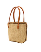 Side view Adele Mini Crochet Raffia Straw Handbag Purse with Colored Edge Natural & Tobacco handmade crochet raffia palm fiber in a solid hue of natural straw color with contrasting narrow band of tobacco dark/cinnamon/brown around the outer edges of the bag with subtle vertical band texture and leather handles - Shebobo