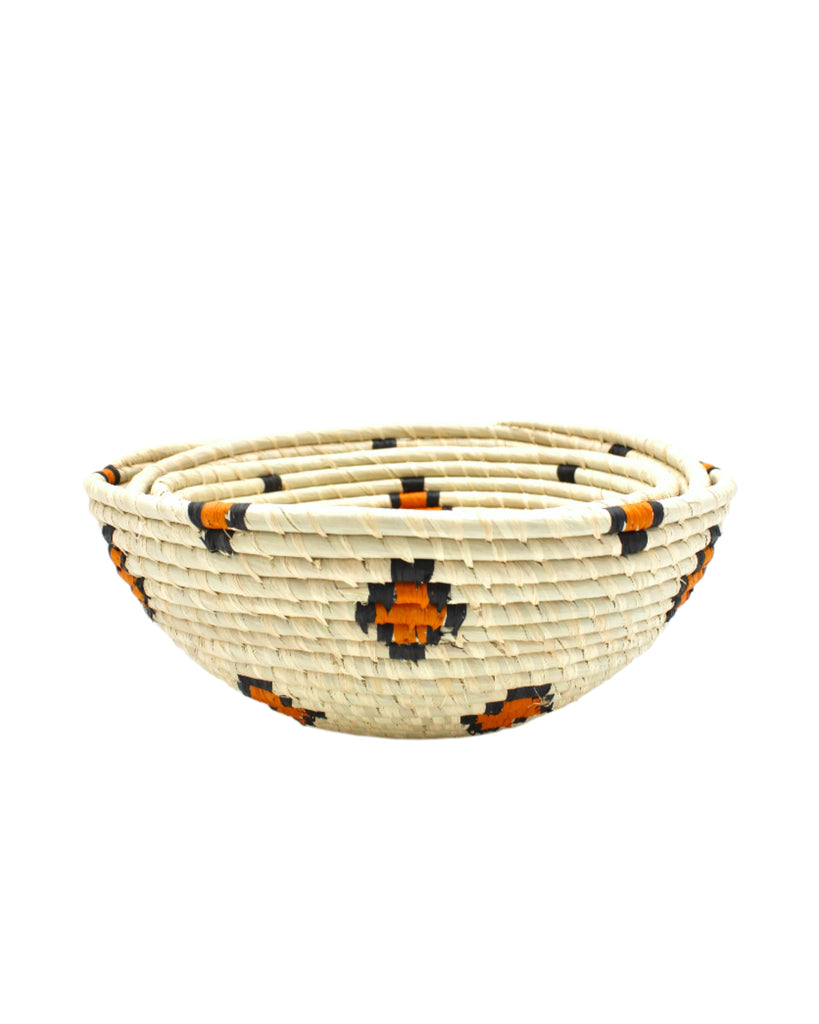 Side view Amara Raffia Straw Decor Display Basket Bowls: Set of 3 handmade woven natural raffia palm fiber in a crochet loop technique concentric coiled circular pattern with natural straw color centered in the bottom with diamond pattern of saffron yellow/orange edged in black around the sides of the bowl with natural straw color base set of small, medium, and large straw display bowls - Shebobo