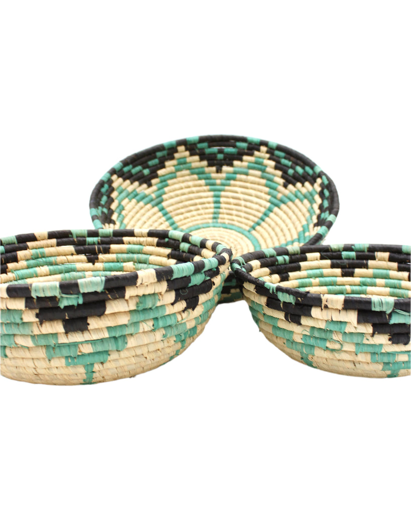 Side view Amara Raffia Straw Decor Display Basket Bowls: Set of 3 handmade woven natural raffia palm fiber in a crochet loop technique concentric coiled circular pattern with natural straw color centered in the bottom with turquoise blue/green, natural, and black geometric floral design pattern up the sides of the bowls set of small, medium, and large straw display bowls - Shebobo