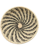 Detail view Amara Raffia Straw Decor Display Basket Bowls: Set of 3 handmade woven natural raffia palm fiber in a crochet loop technique concentric coiled circular pattern with natural straw color centered in the bottom and that go up the sides of the bowls with contrasting black swirl stitch pattern and matching natural rim/edge set of small, medium, and large straw display bowls - Shebobo
